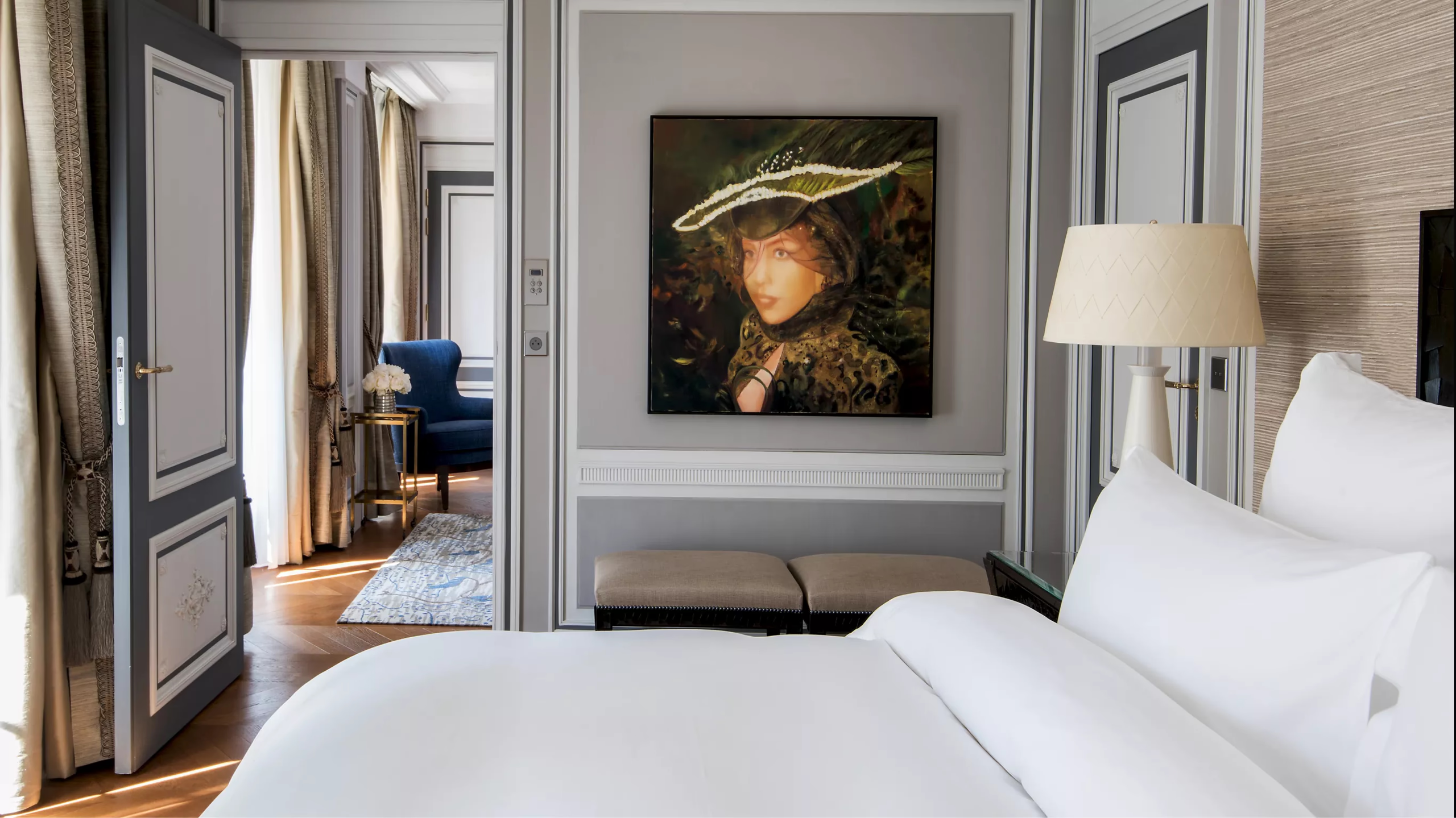 Hôtel de Crillon: bedroom with gray paneling, doorway to sitting room, and contemporary artwork