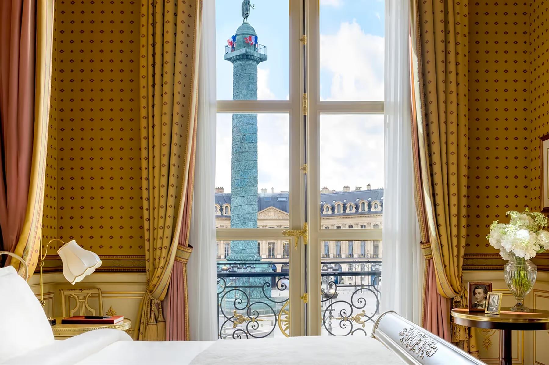 Ritz Paris: a room window framing the Vendôme Column with golden curtains and cream furnishings