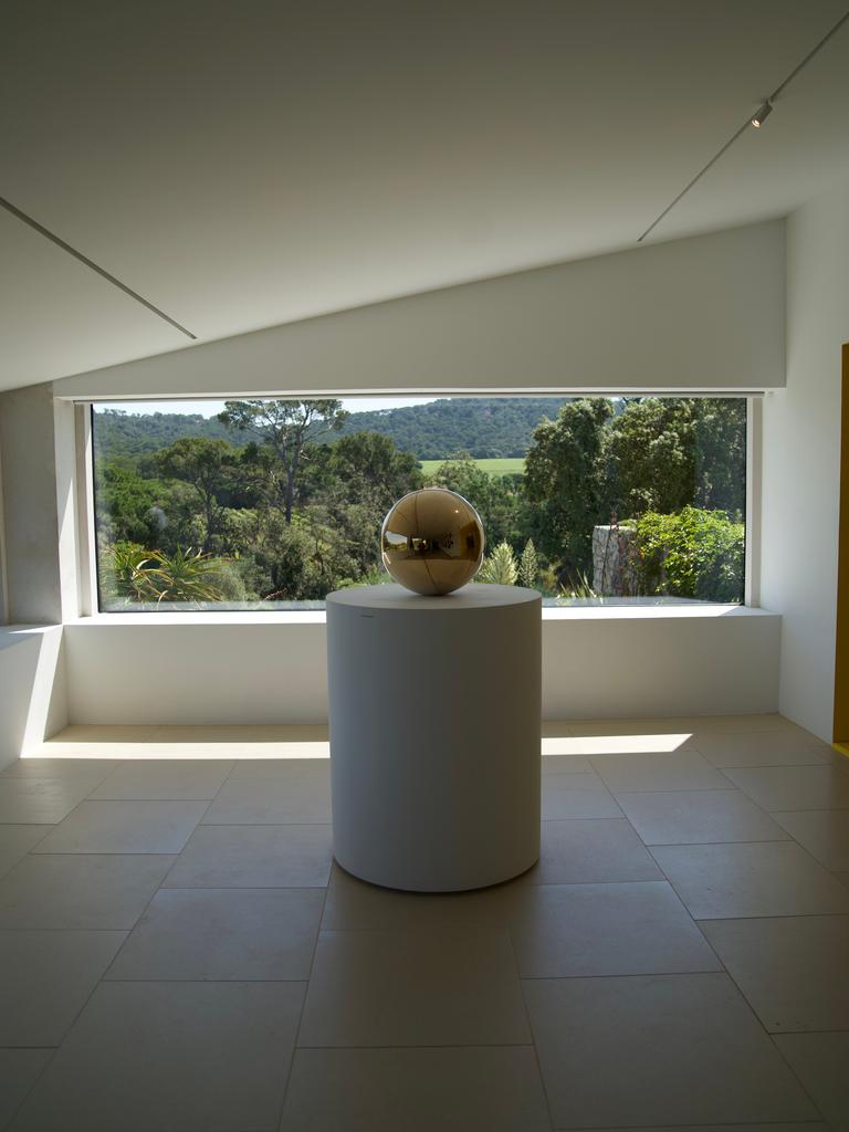 A gilded sphere on a pedestal in the gallery at the Fondation Carmignac