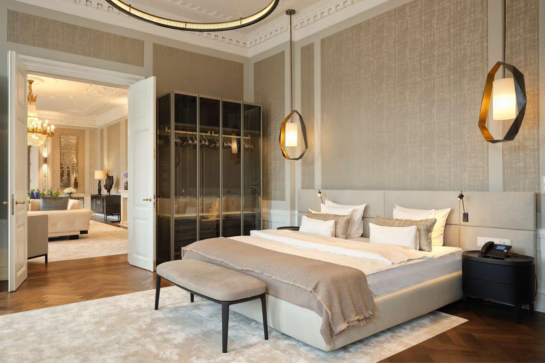 Hotel d’Angleterre: a suite bedroom with smoked oak furnishings and brass pendant lights
