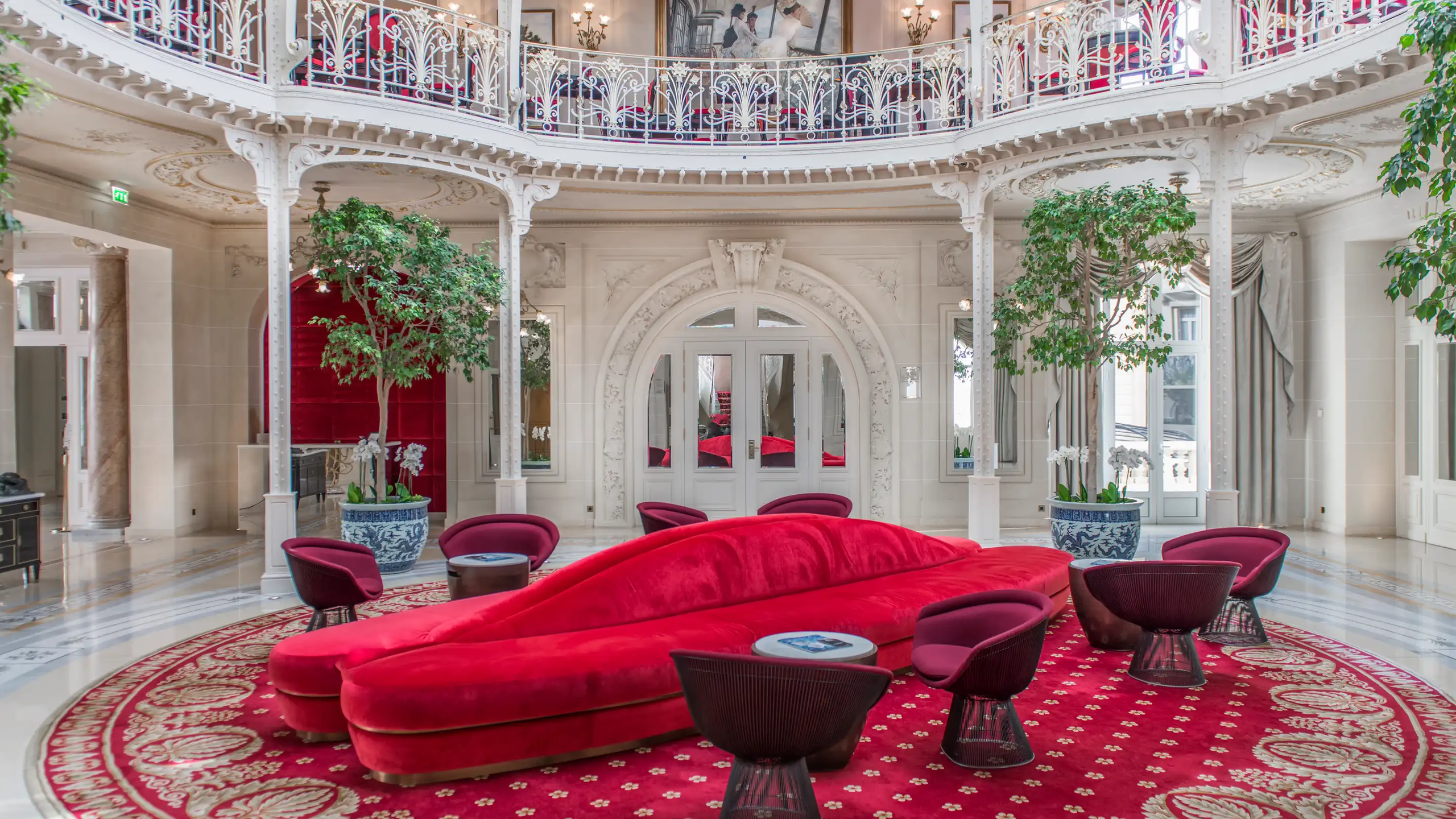 Hôtel Hermitage Monte-Carlo: grand interior with red-upholstered curved seating, mirrored walls and painted dome ceiling