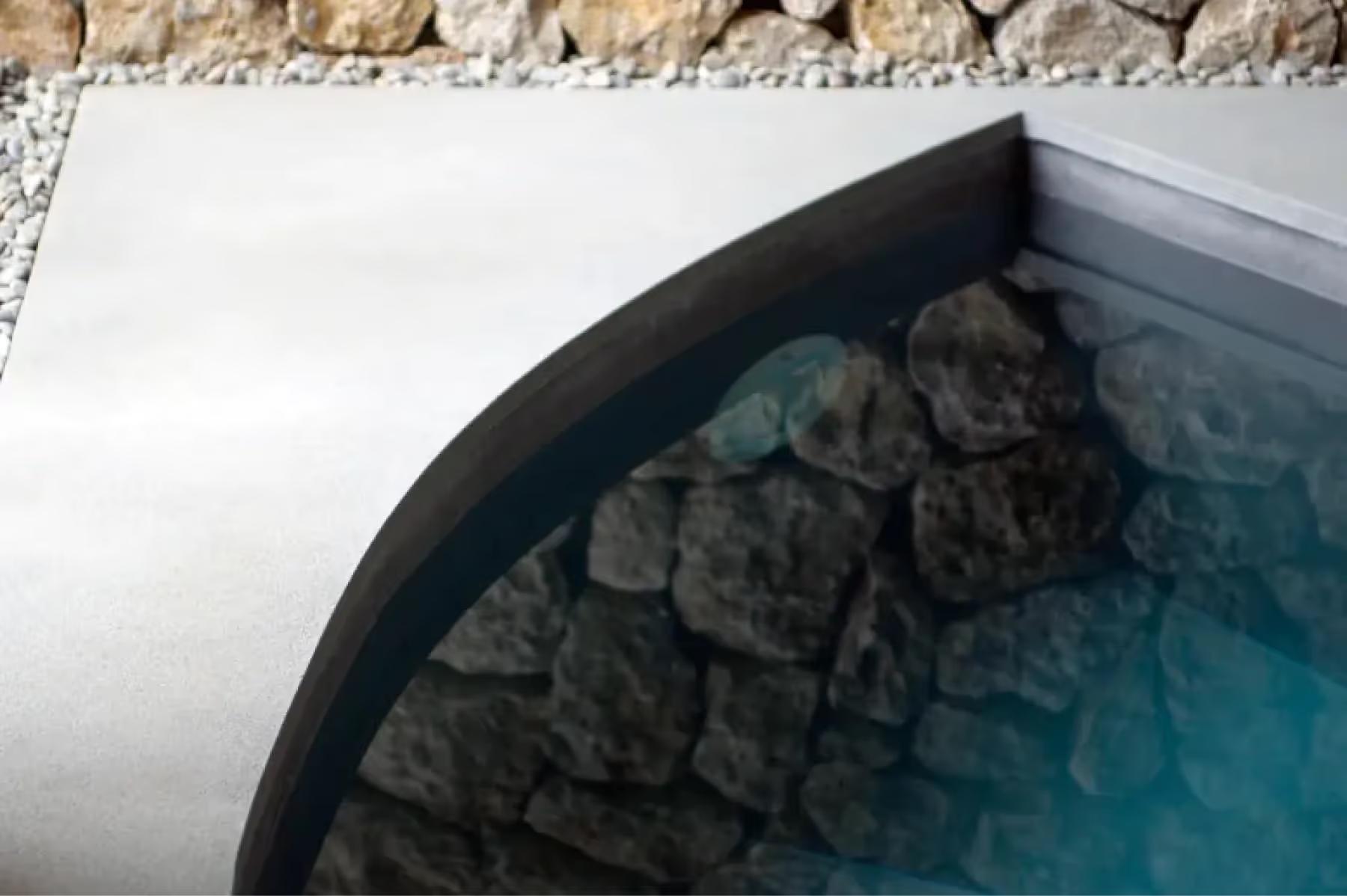 Es Racó d’Artà: saltwater pool edge with natural stone features and turquoise water