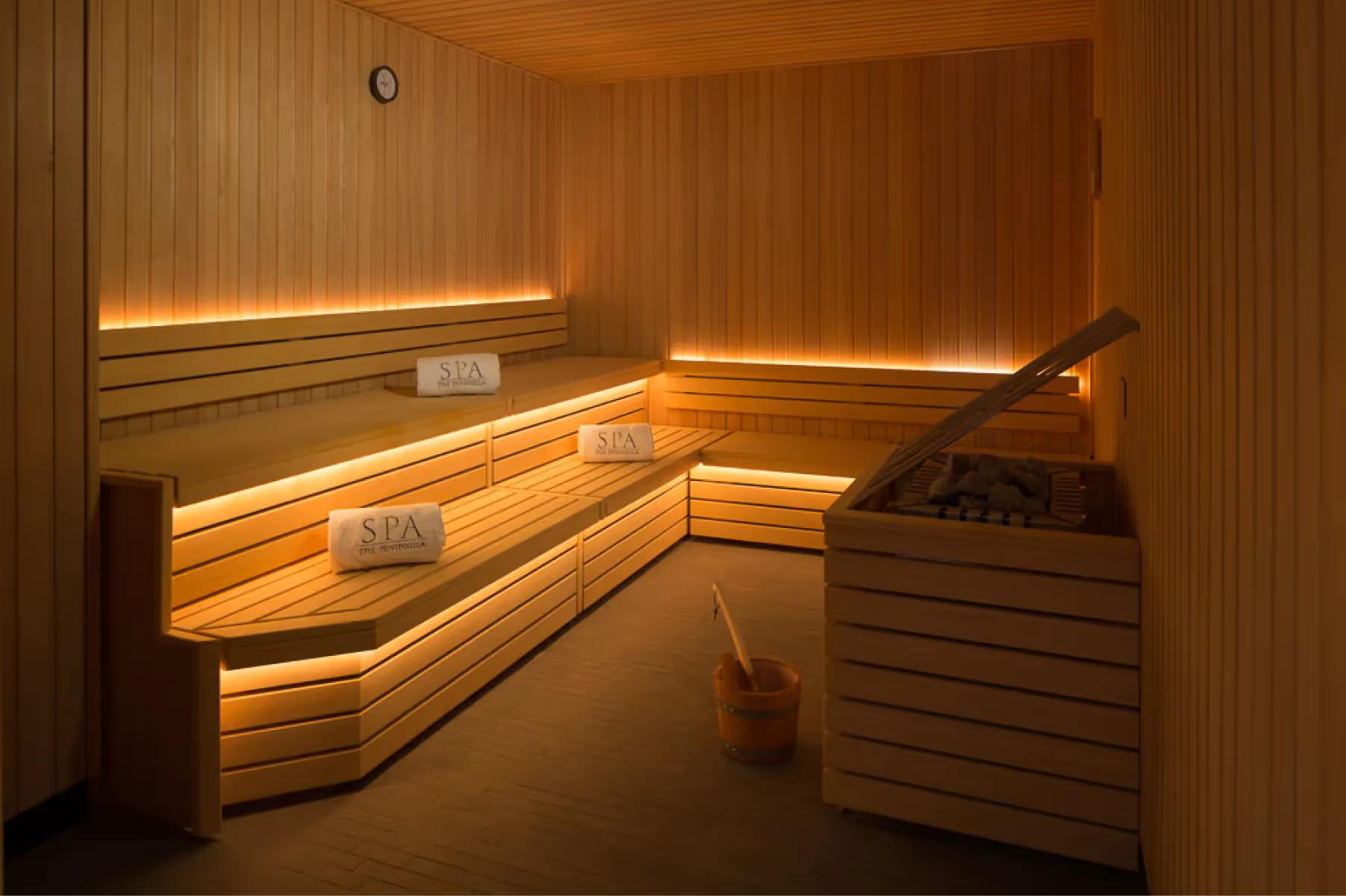 Sauna interior with horizontal cedar paneling and interior bench seating