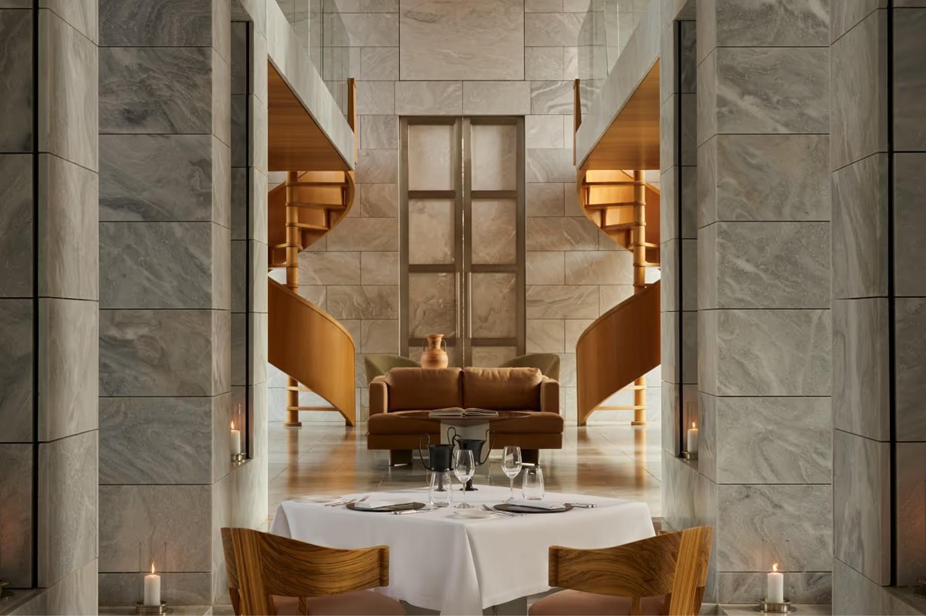 Minimalist restaurant with white tablecloths and symmetrical plaster columns