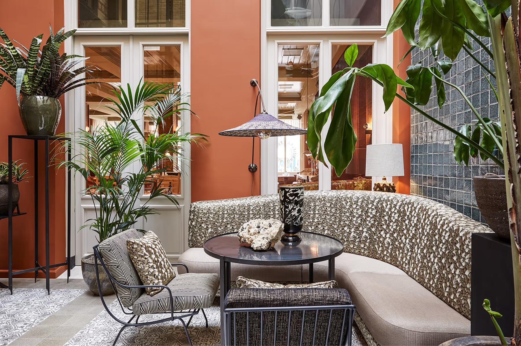 De L’Europe Amsterdam: outdoor patio with terracotta accents, potted plants, and modern furnishings
