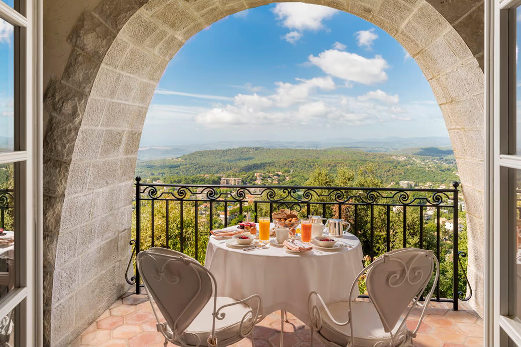 Château Saint Martin & Spa: arched stone terrace with table set for intimate dinner overlooking valley