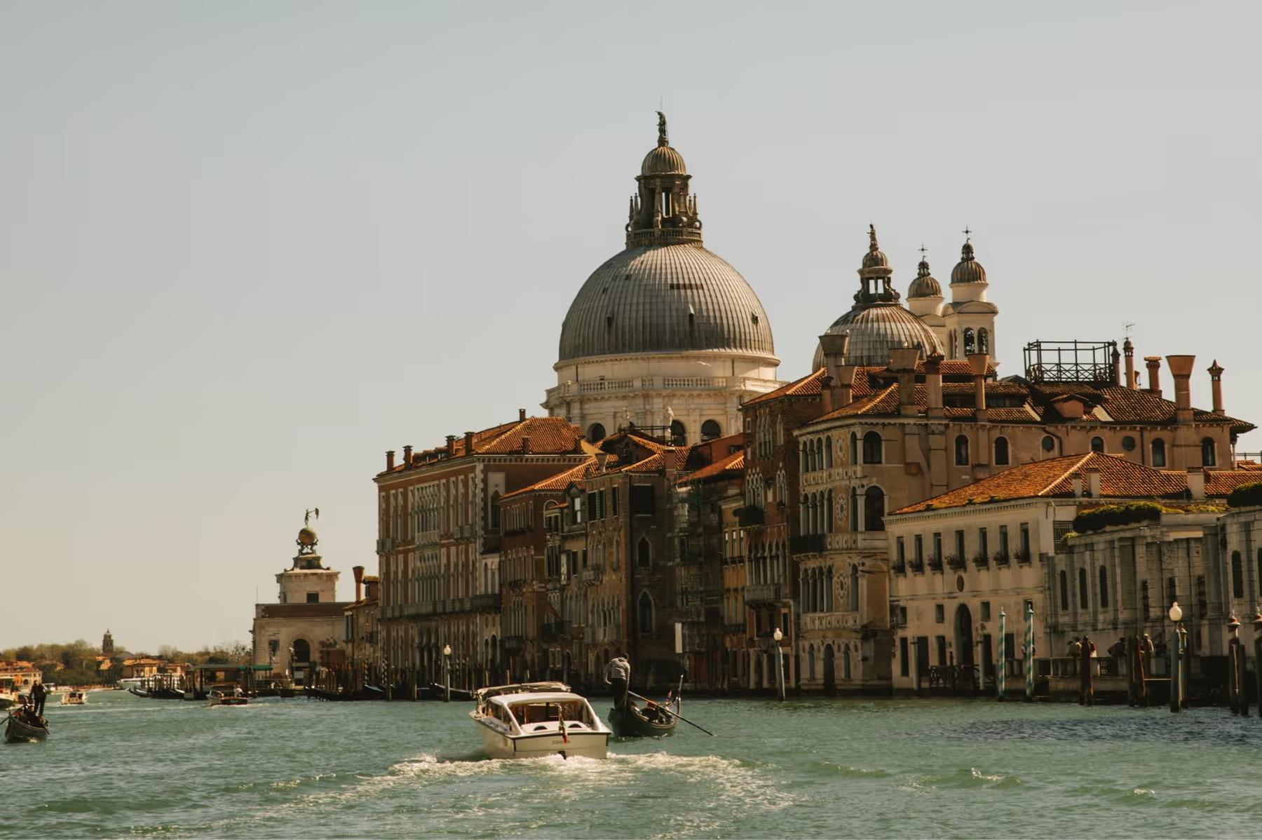 The Basilica di Santa Maria della Salute and Grand Canal buildings viewed from the water at dusk