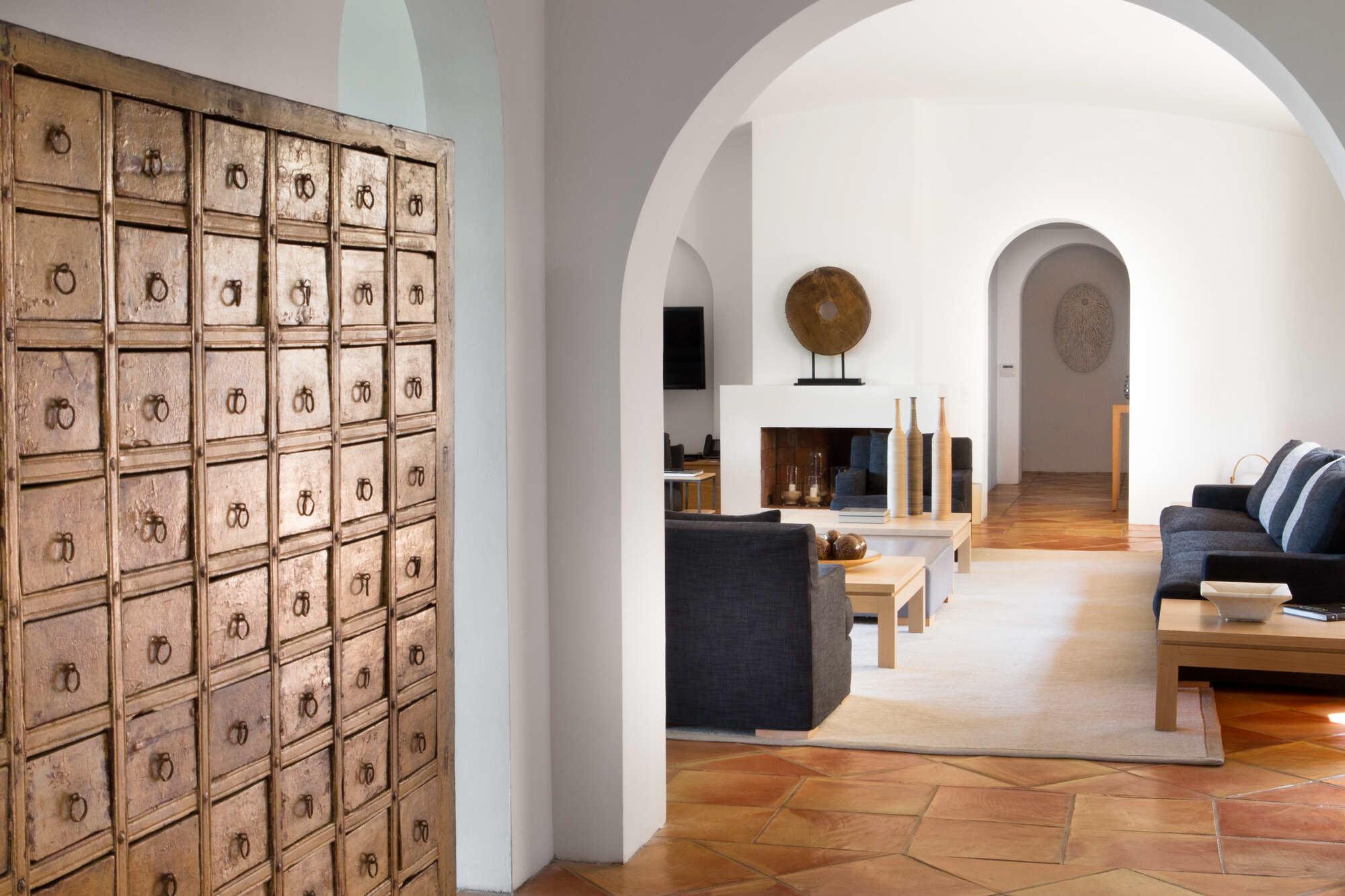 Light-filled interior with arched doorway and minimalist furnishings