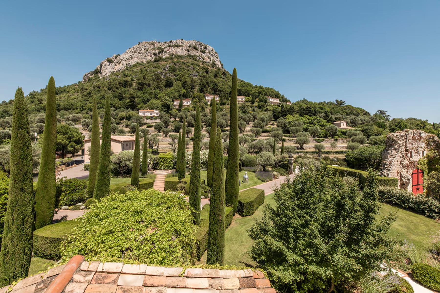 Château Saint Martin & Spa: hilltop terrain with cypress trees and rock formations overlooking valley