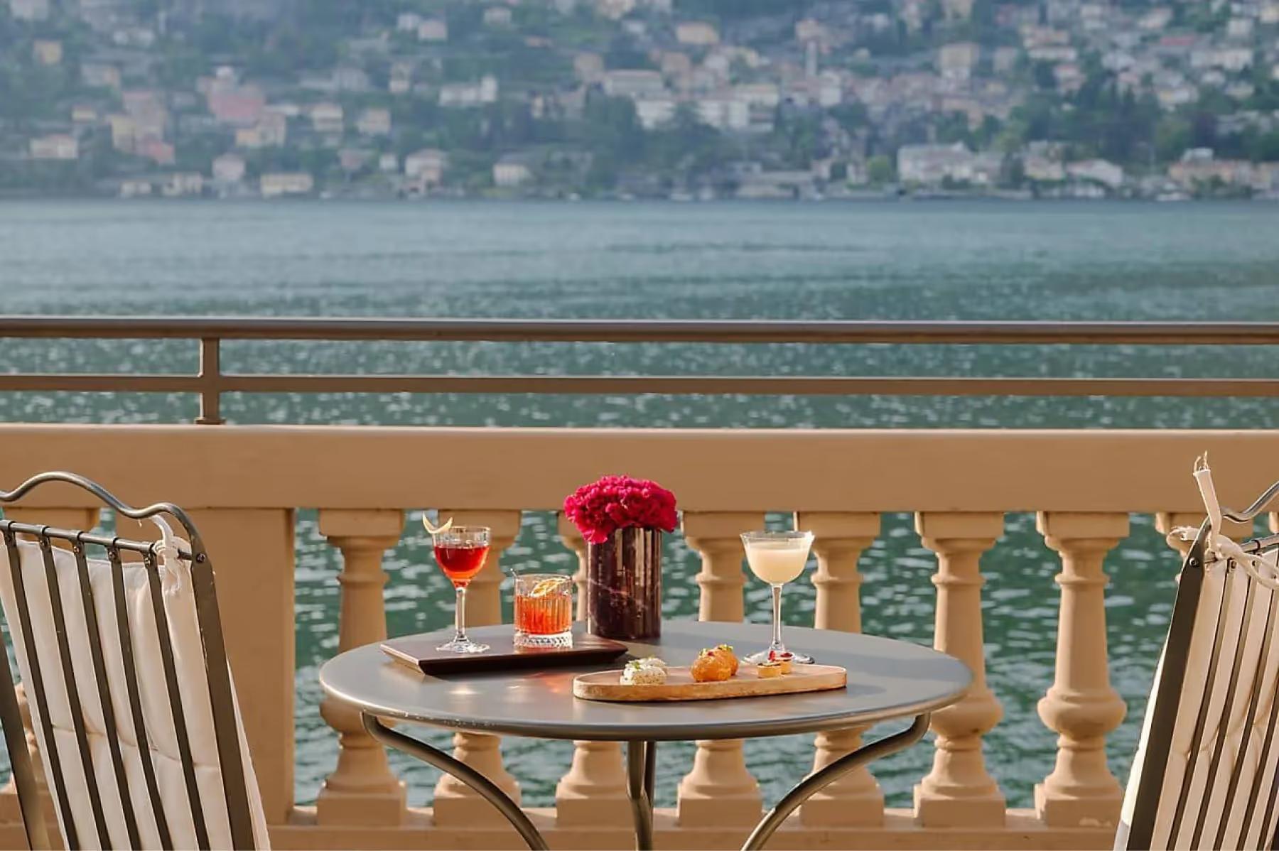 Mandarin Oriental, Lake Como: lakeside table set for two with lake views across railing and distant hillside villages