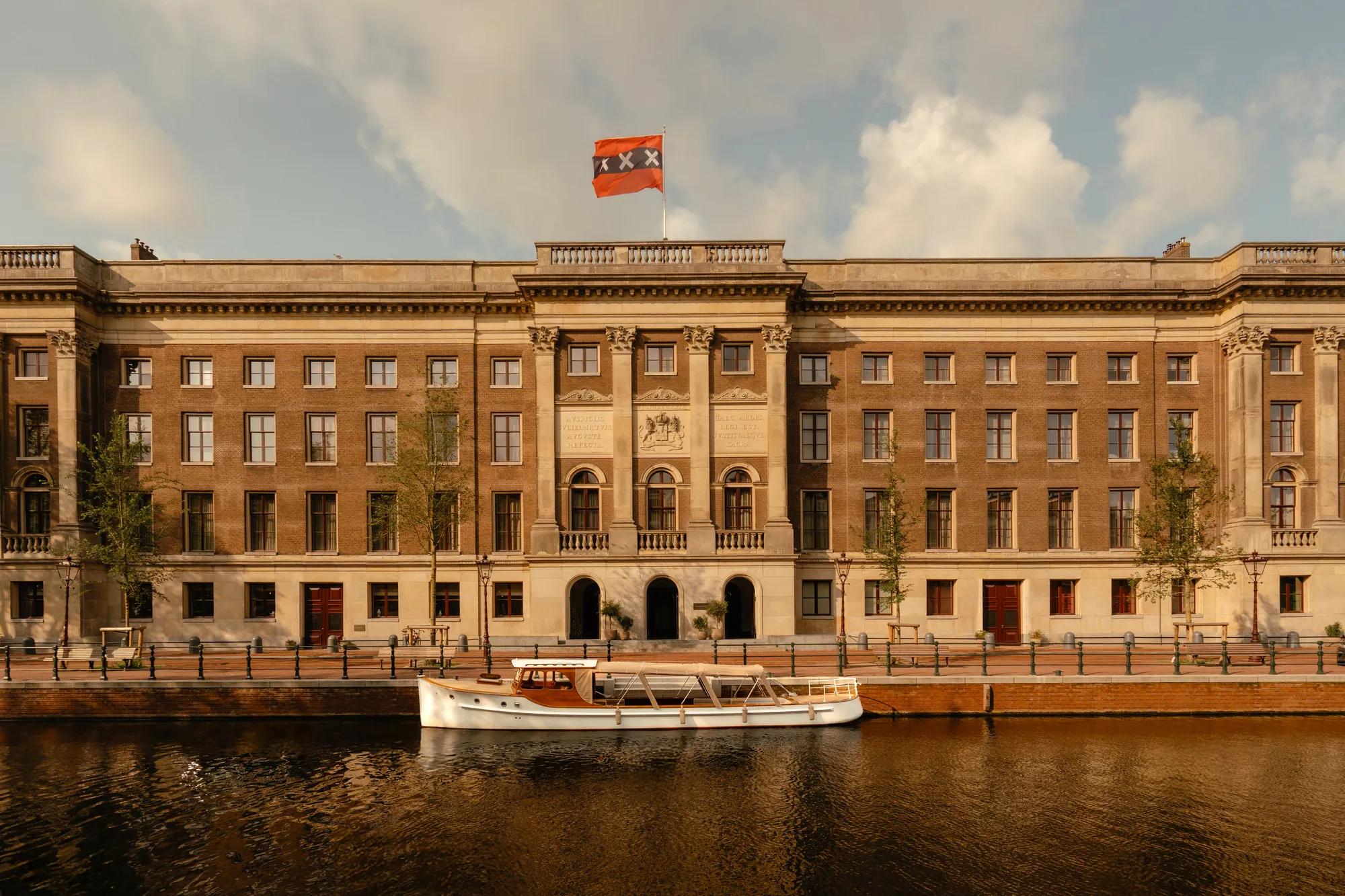 Rosewood Amsterdam: the former Palace of Justice on the Prinsengracht, with the hotel’s salon boat moored on the canal