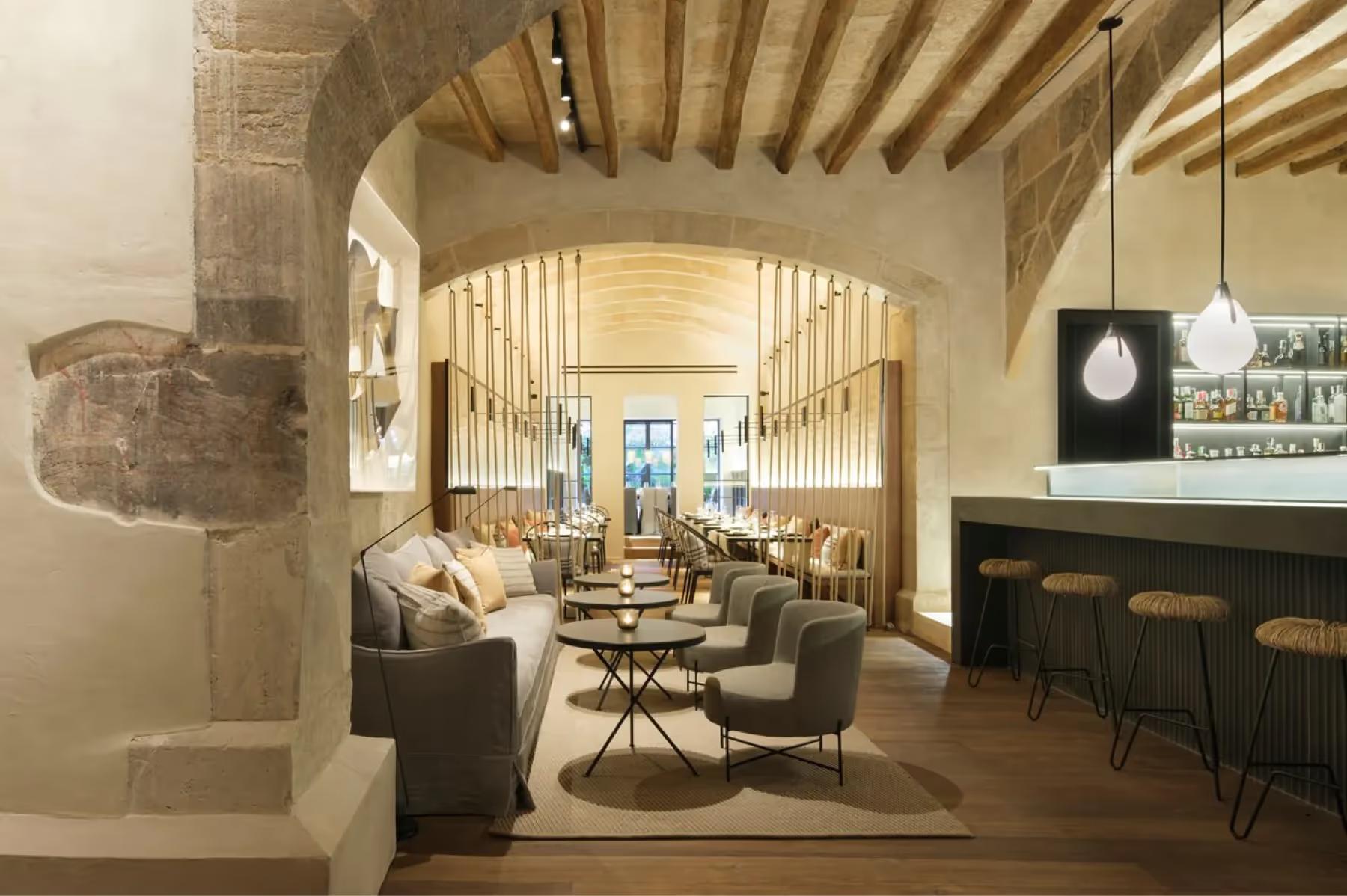 Can Ferrereta: restaurant interior with wooden barrel ceiling and sophisticated seating area
