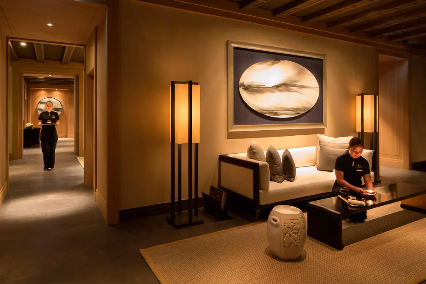 The Peninsula: spa treatment room with neutral palette, bench seating, and focused overhead lighting