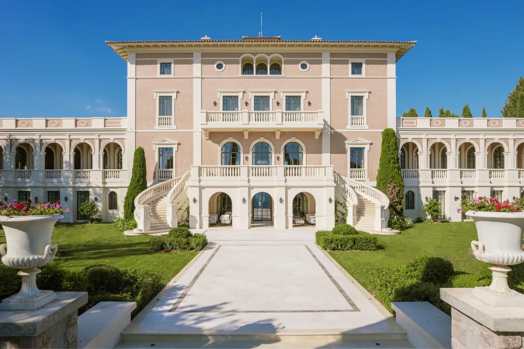 Le Château de La Croix des Gardes: classical château façade with symmetrical columns, arched openings, and formal garden approach