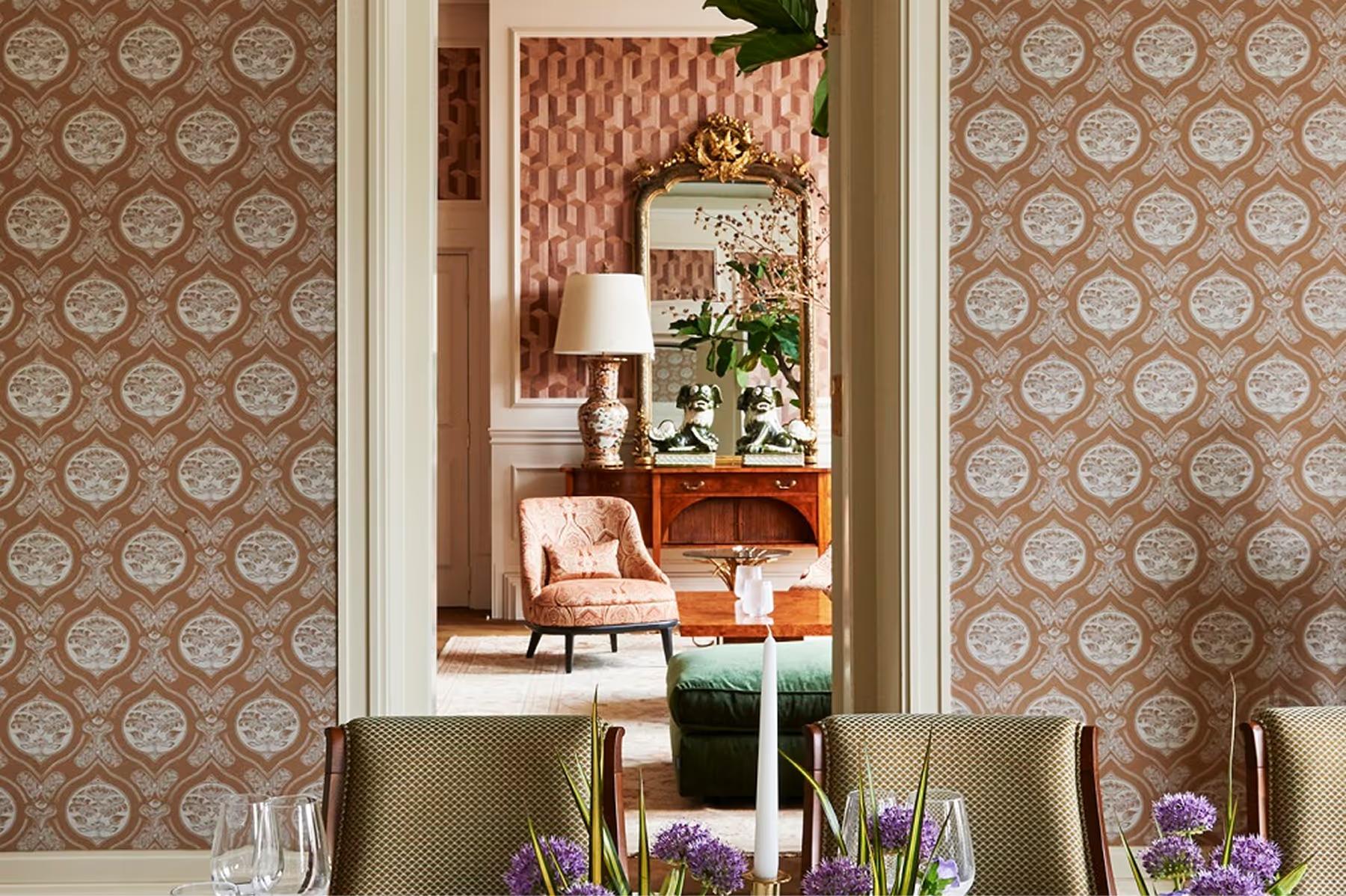Lounge interior with patterned wallpaper, warm lighting, and elegant furnishings