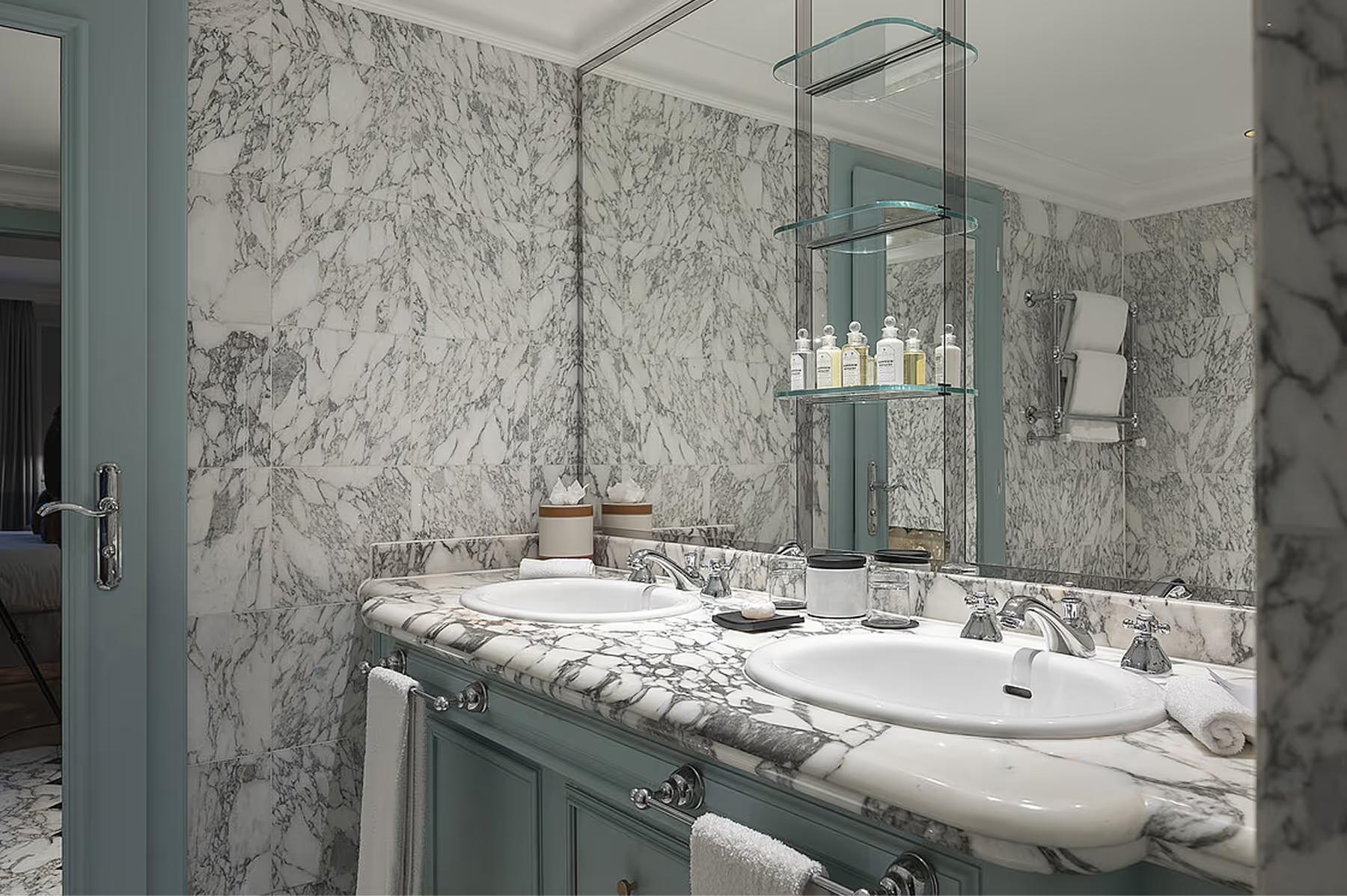 Marble-clad ensuite with double vanity and large mirror