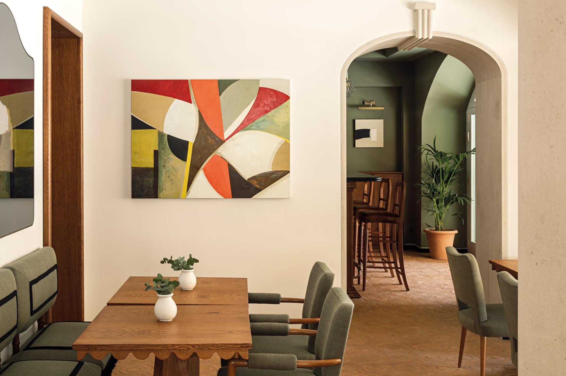 Dining room with geometric wall art and multiple seating areas