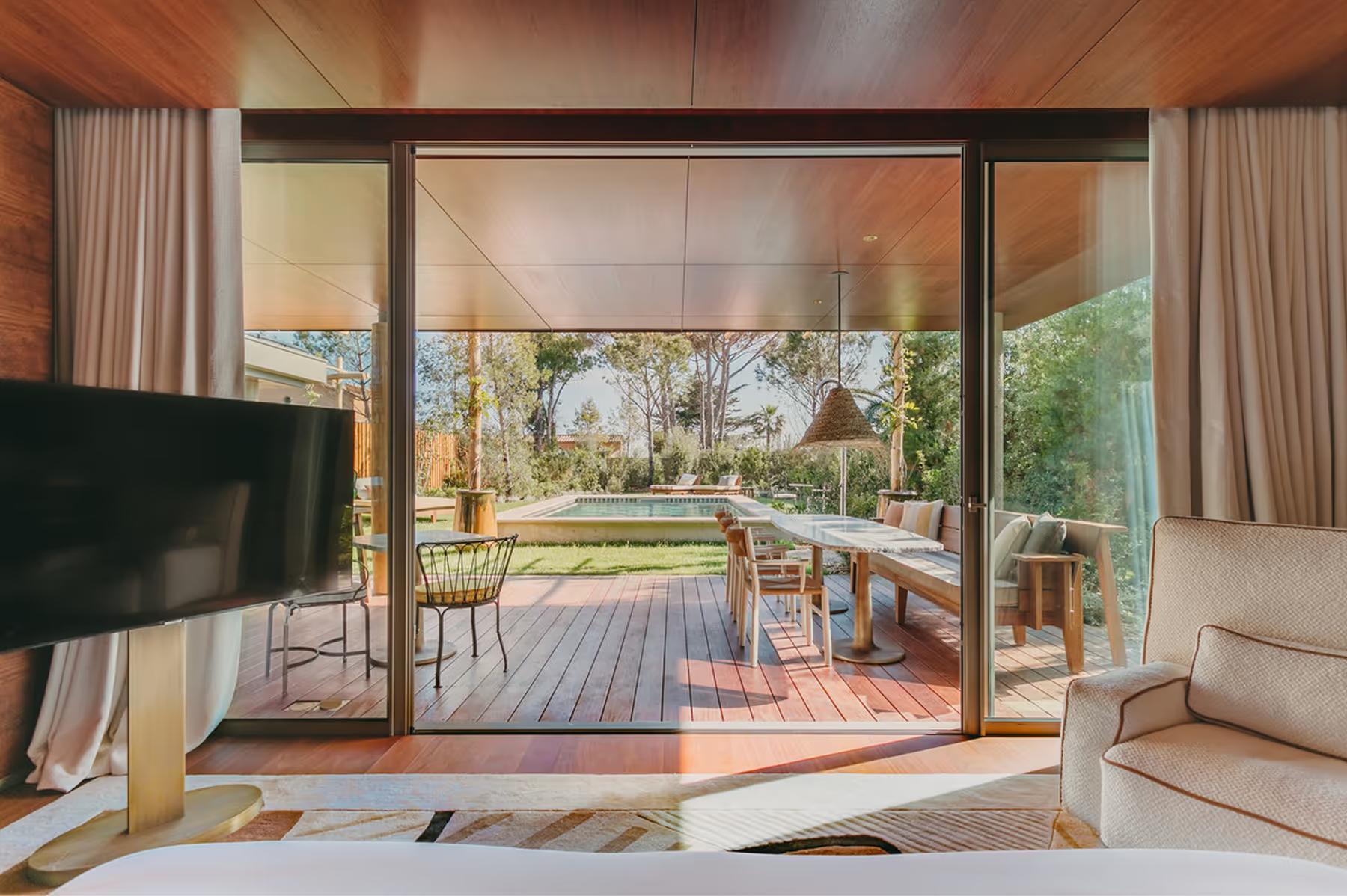 Lily of the Valley: bedroom with glass doors opening to terrace and landscape vista