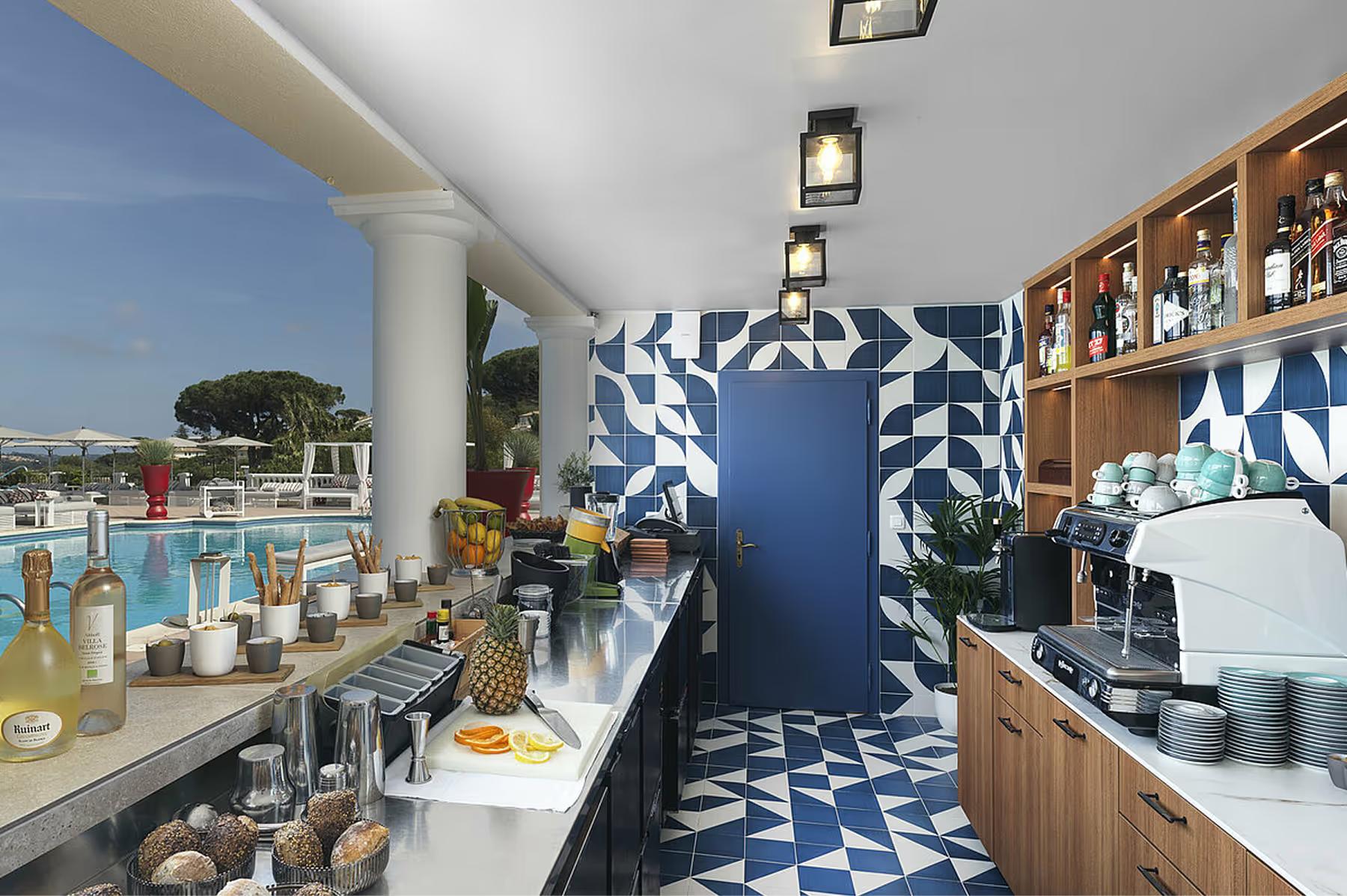 Nautical-blue bar area with polished service counter and geometric floor