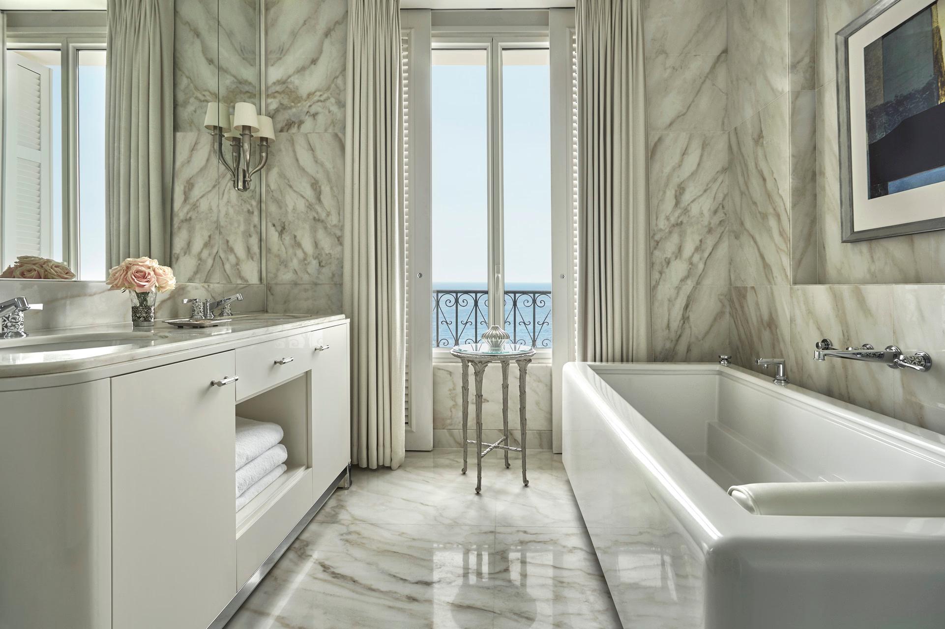 Grand-Hôtel du Cap-Ferrat: marble bathroom with soaking tub positioned toward a sea-view window