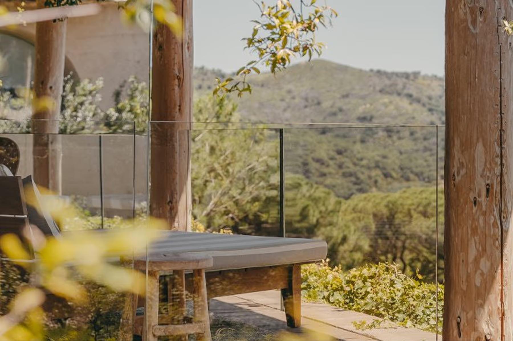 Lily of the Valley: desk beside large window with distant hills framed by wooden beams