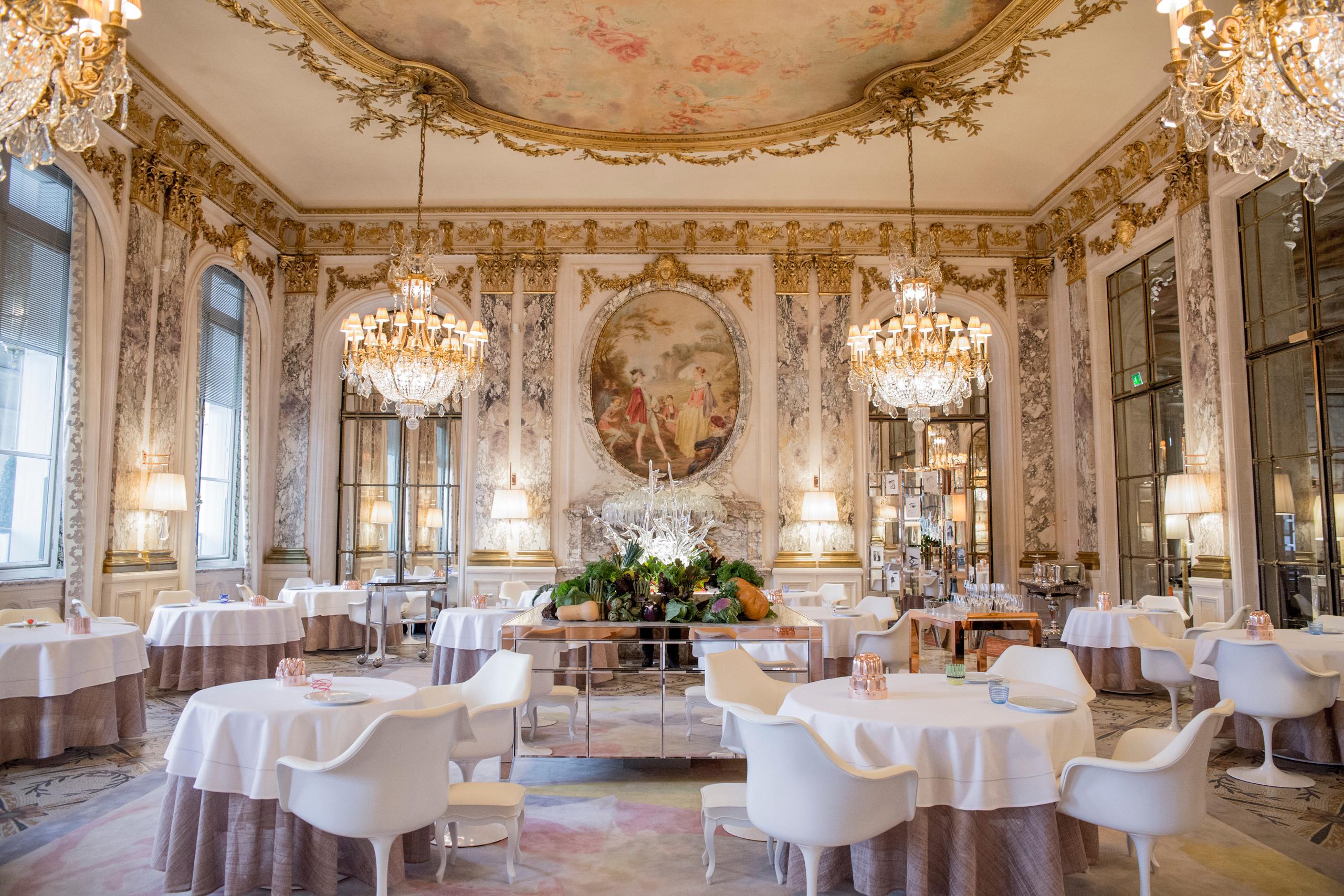 The grand dining room with ornate frescoed ceiling, classical proportions, and formal table settings