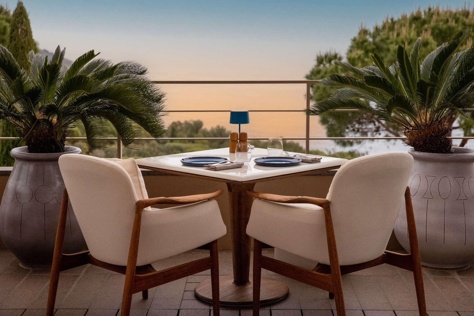 La Réserve Ramatuelle: two white chairs at a round table overlooking the sea