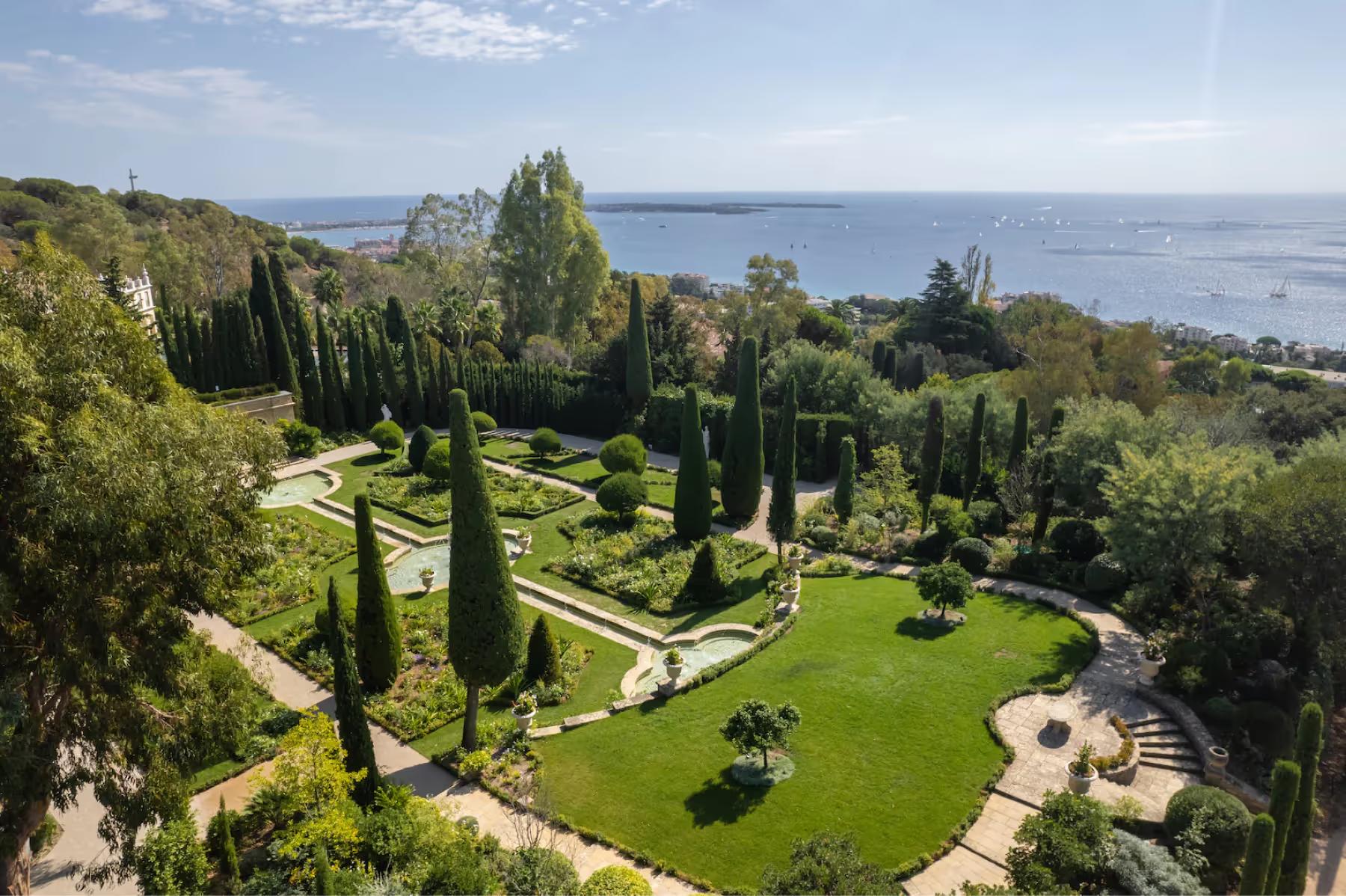 Le Château de La Croix des Gardes: rectangular pool overlooking sea, lined with cypress trees and sun loungers on paved terrace