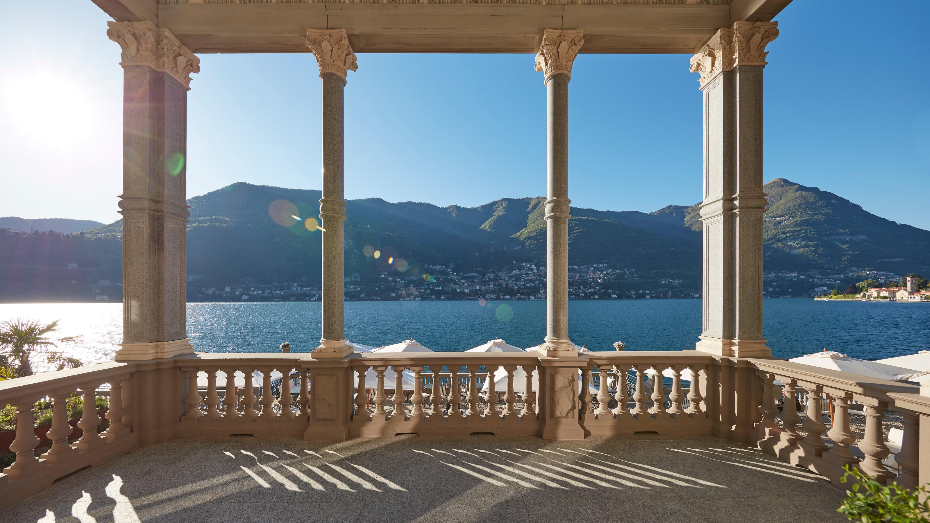 Neoclassical loggia with columns overlooking Lake Como in afternoon light