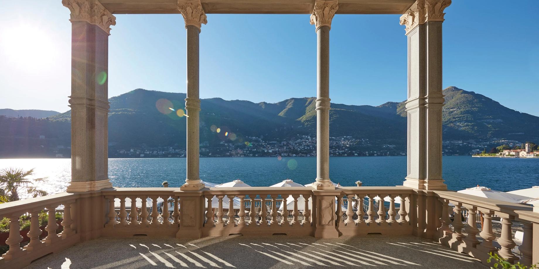 Neoclassical loggia with columns overlooking Lake Como in afternoon light
