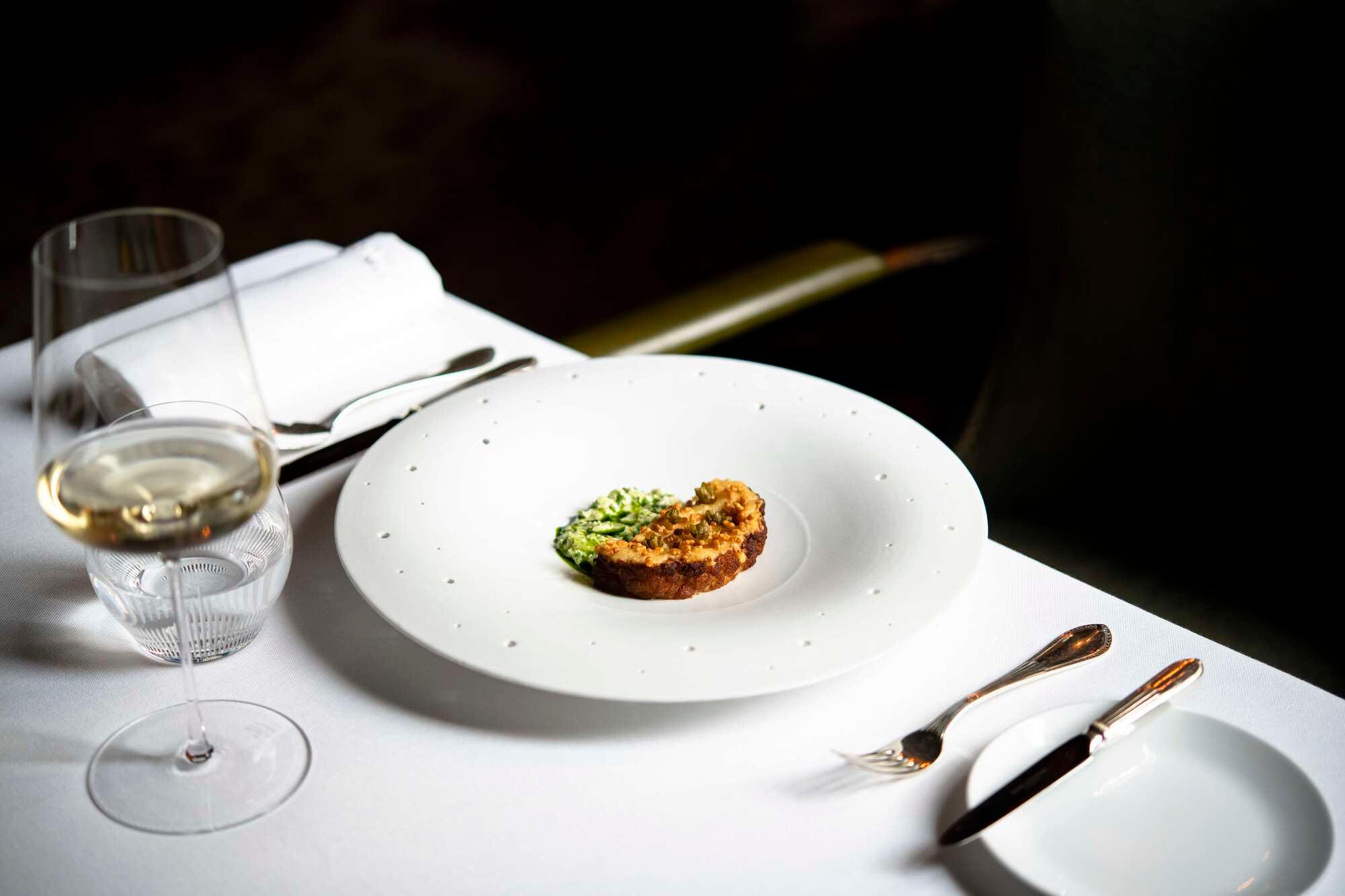 La Réserve Paris: a fine dining plate with wine glass and formal place setting