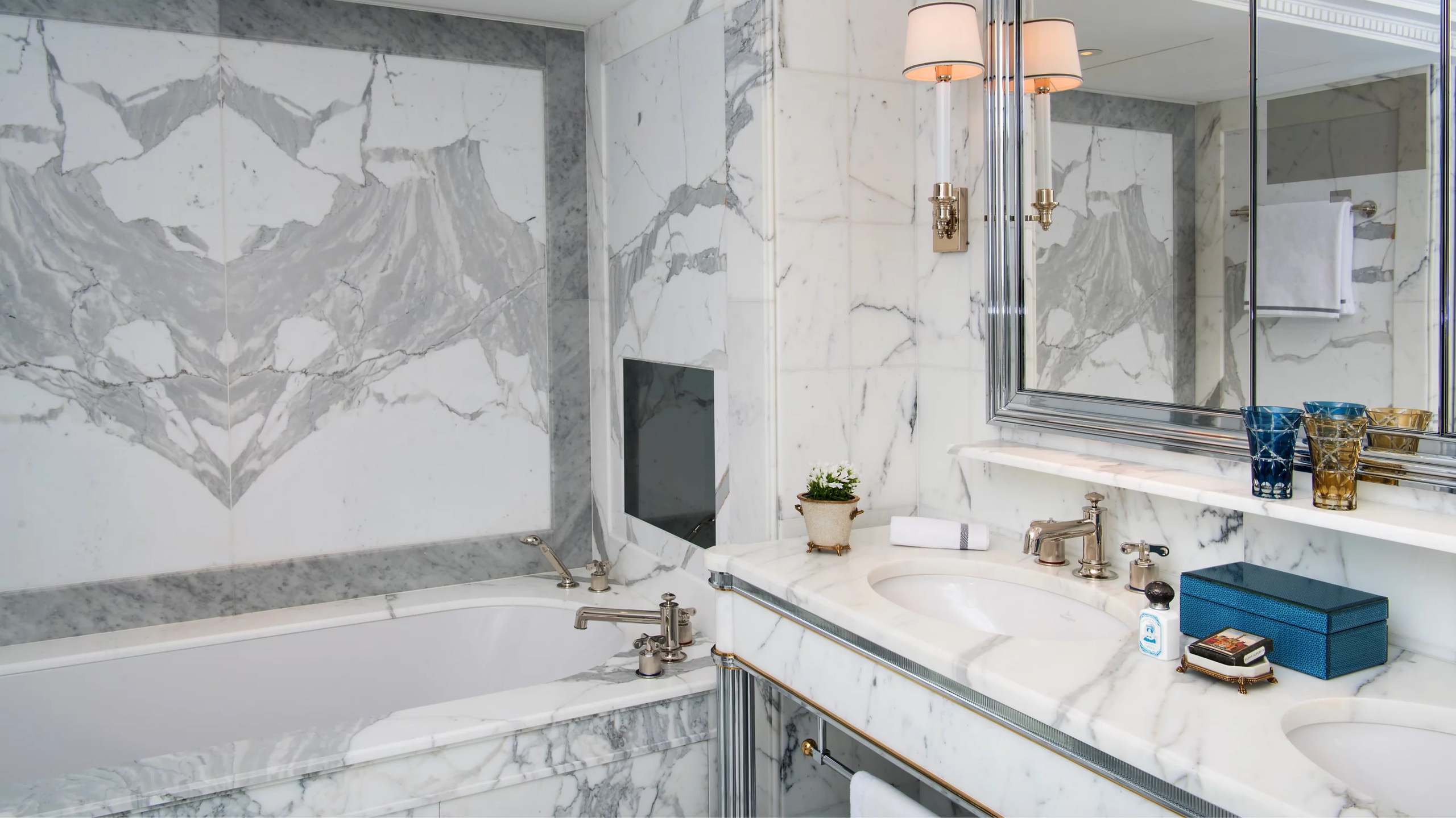 Hôtel de Crillon: suite with bed and dressing area, marble walls, and modern amenities in classical setting