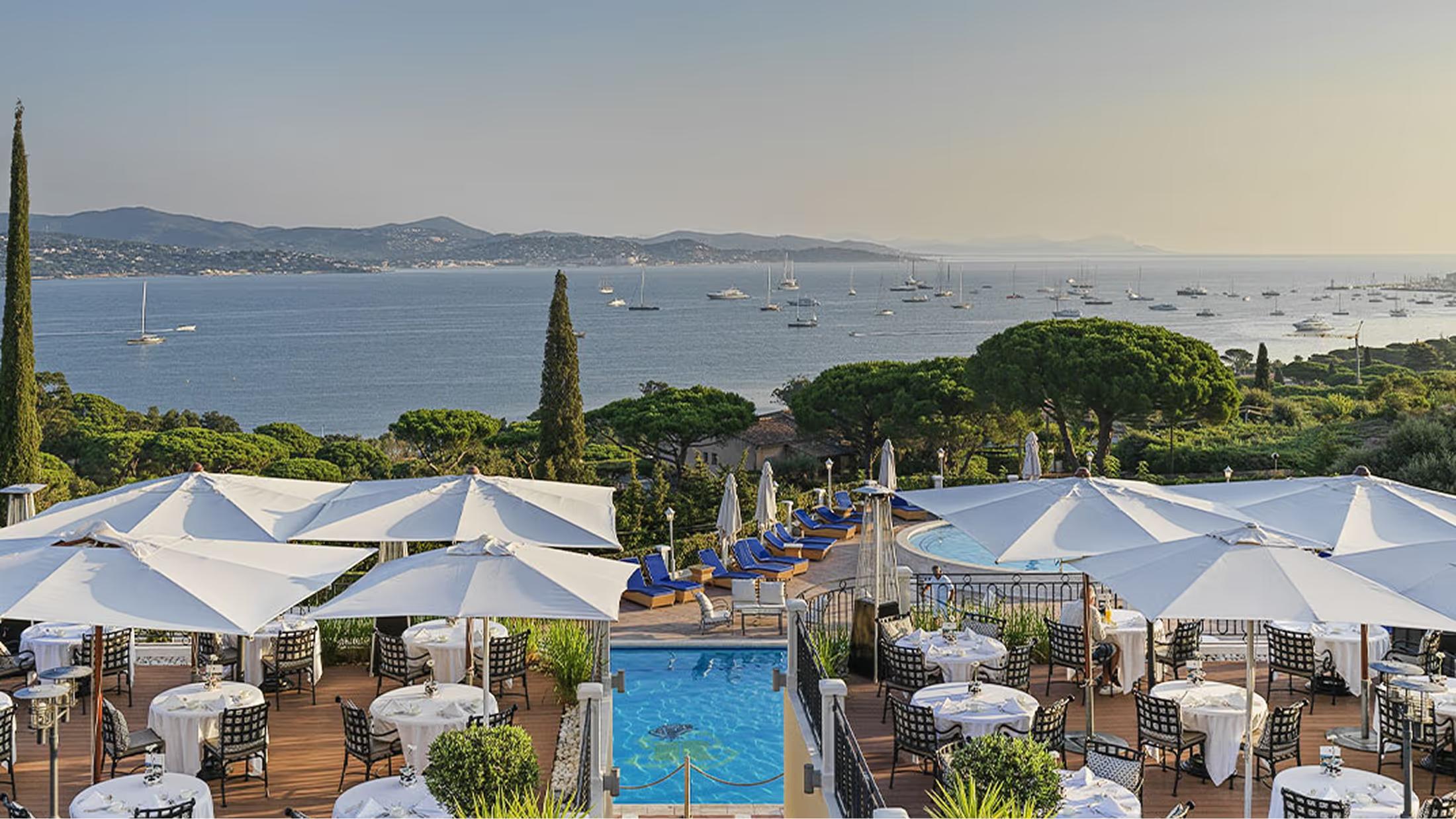 The terrace restaurant with blue umbrellas and sea views over the Gulf of Saint-Tropez