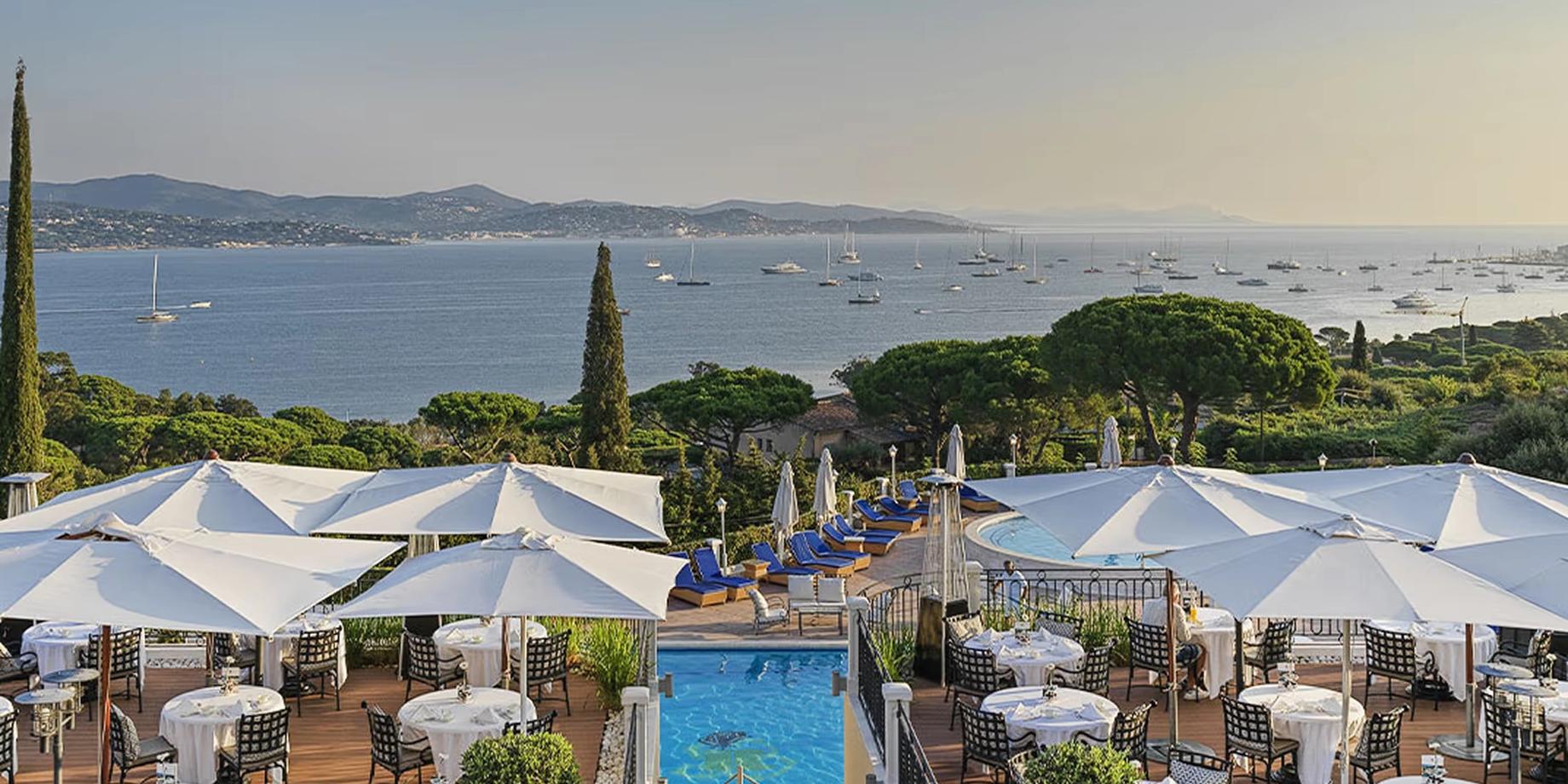 The terrace restaurant with blue umbrellas and sea views over the Gulf of Saint-Tropez