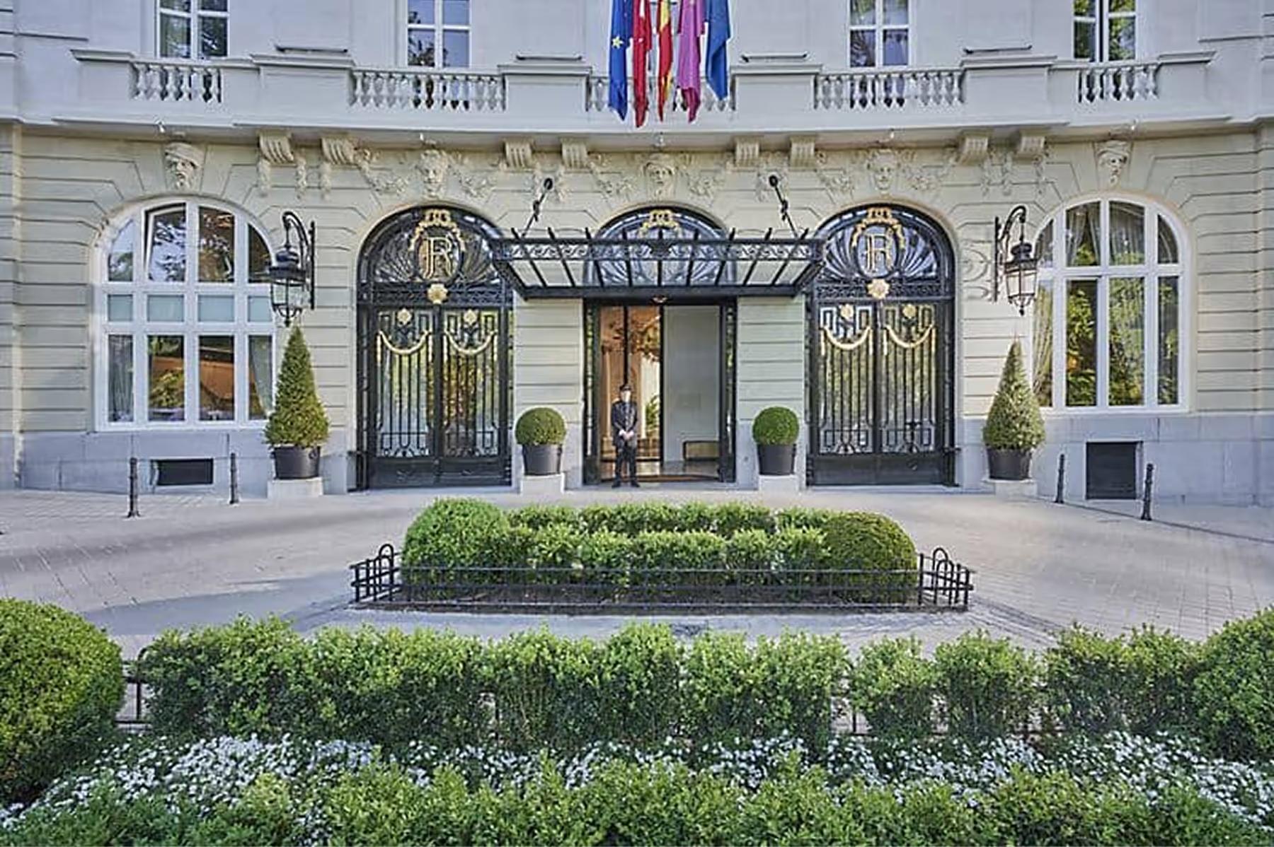 Mandarin Oriental Ritz, Madrid: elegant neoclassical entrance facade with manicured gardens and arched doors