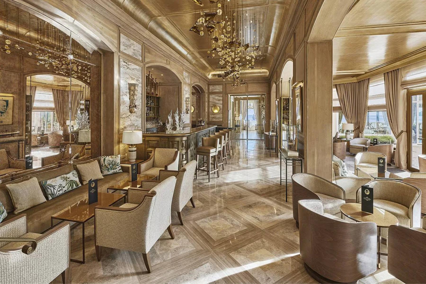 La Réserve de Beaulieu: grand salon with coffered ceiling and multiple seating arrangements