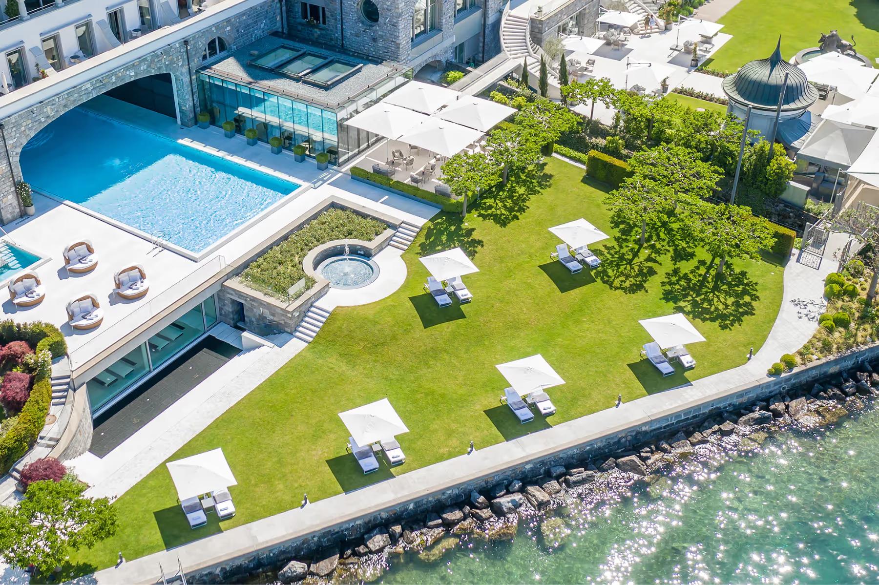 Park Hotel Vitznau: aerial view of hotel grounds with swimming pool and manicured lawns