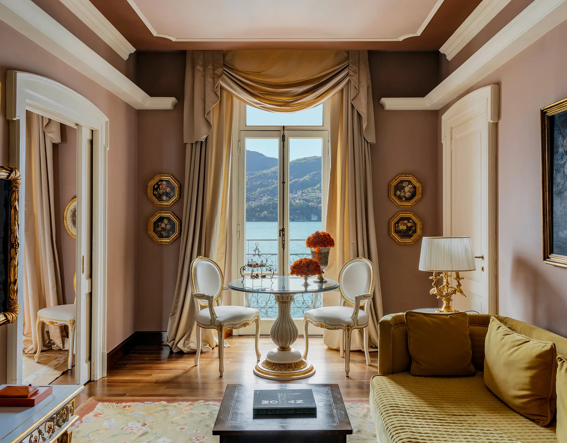 Grand Hotel Tremezzo: a suite room with draped windows, gold furnishings, and lake-view doors