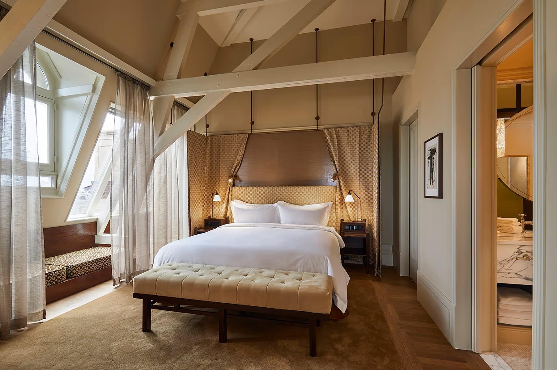 De L’Europe Amsterdam: bedroom with four-poster canopy bed, white linens, and sheer drapes with river views