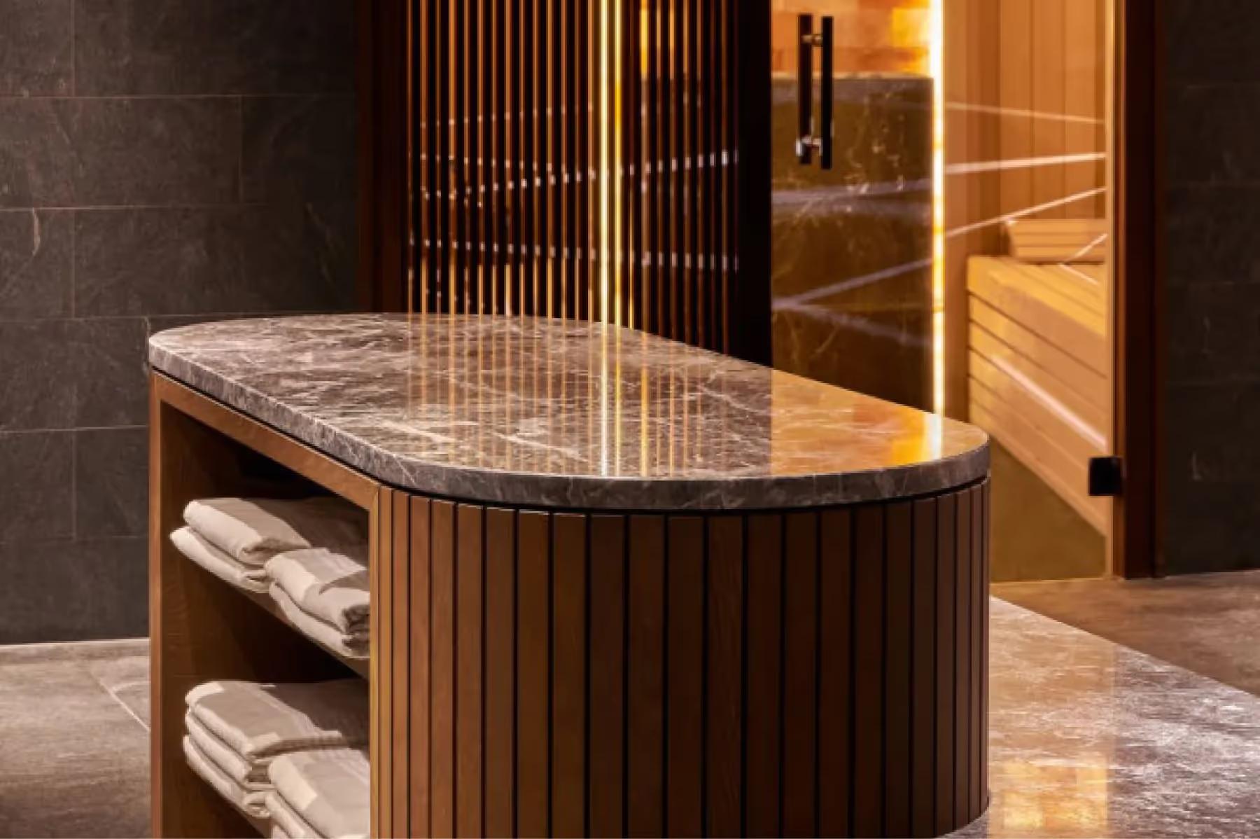 Spa treatment area with marble countertop, wood paneling, and ambient lighting
