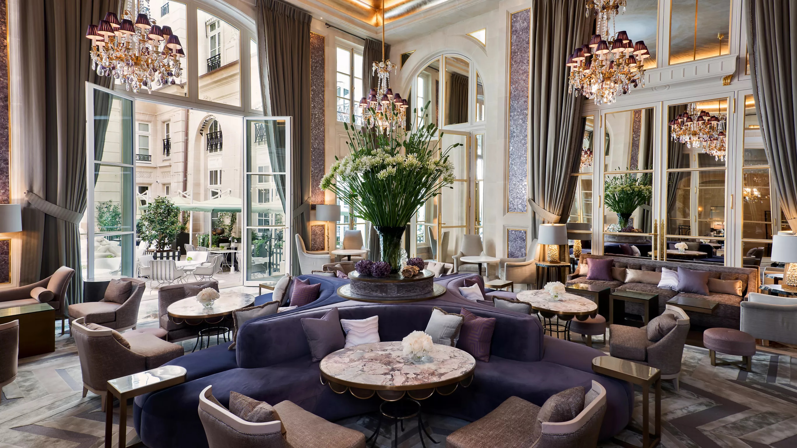 Hôtel de Crillon: grand dining room with soaring columns, floral arrangements, and crystal lighting