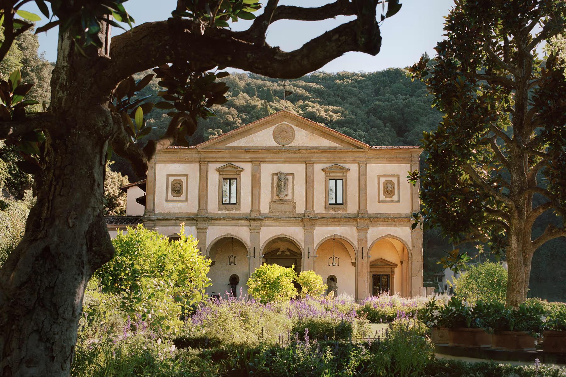 Villa San Michele: the Renaissance facade beneath cypress trees with Fiesole’s forested landscape beyond