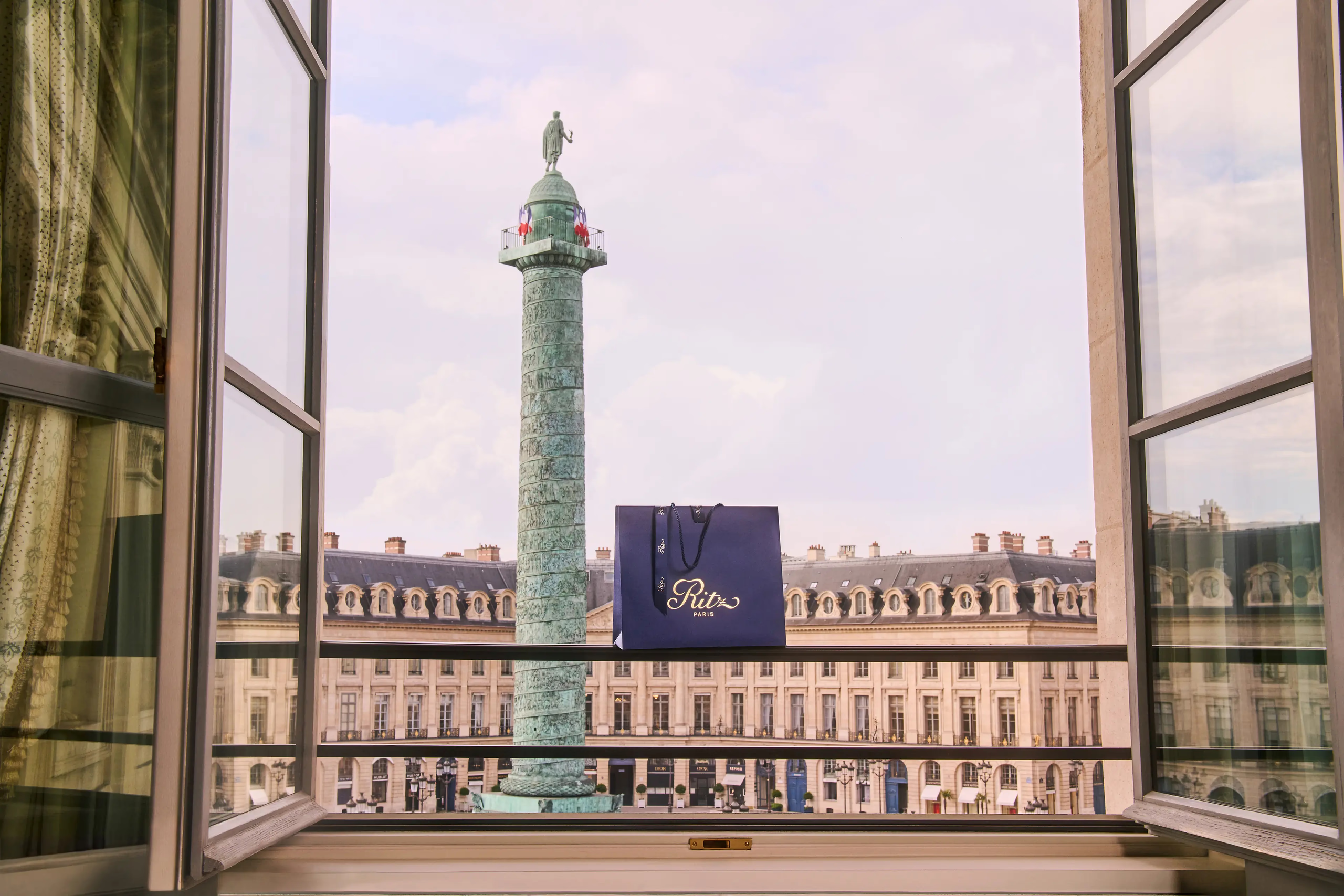 Ritz Paris: the Vendôme Column framed through French doors from a suite window