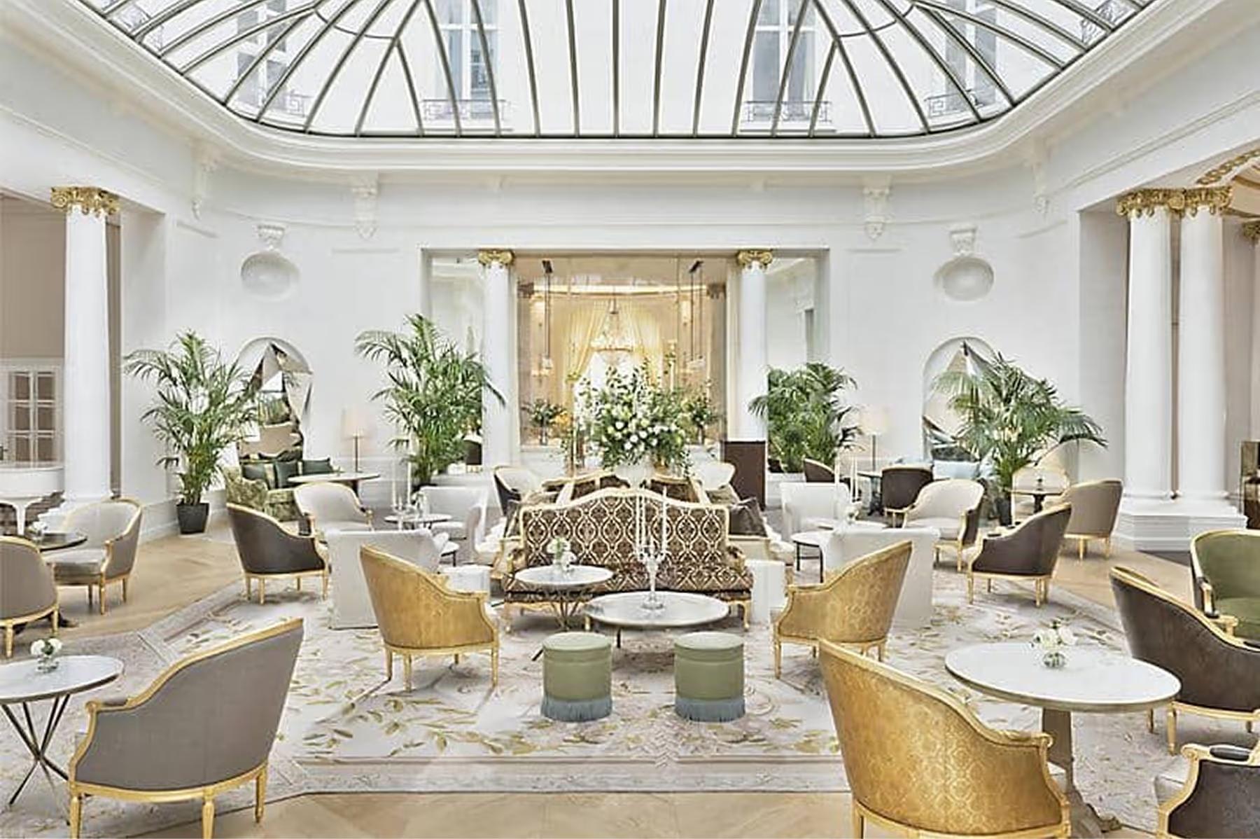 Mandarin Oriental Ritz, Madrid: grand lobby with arched glass ceiling, potted plants, and gold-frame furniture