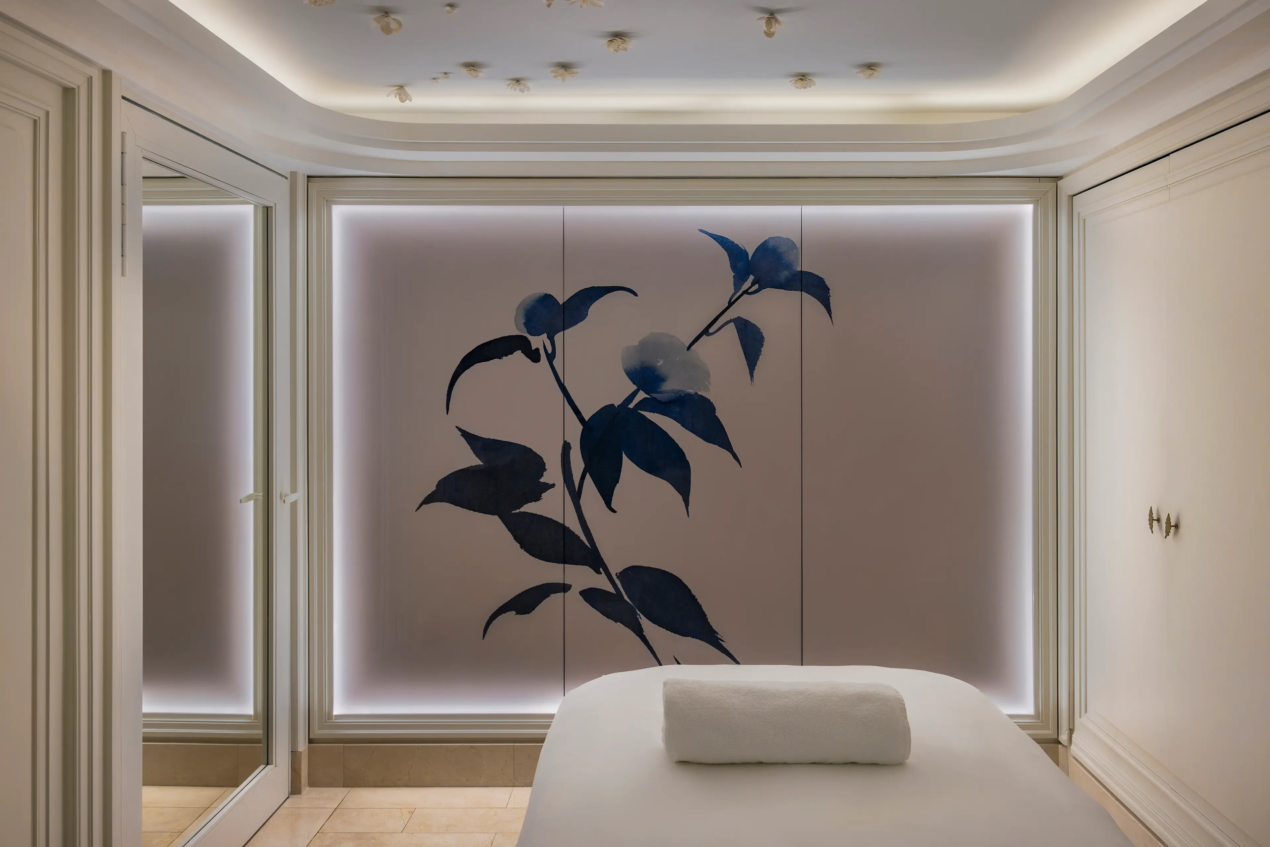 Ritz Paris: a treatment room with massage table, botanical art installation, and soft ambient light