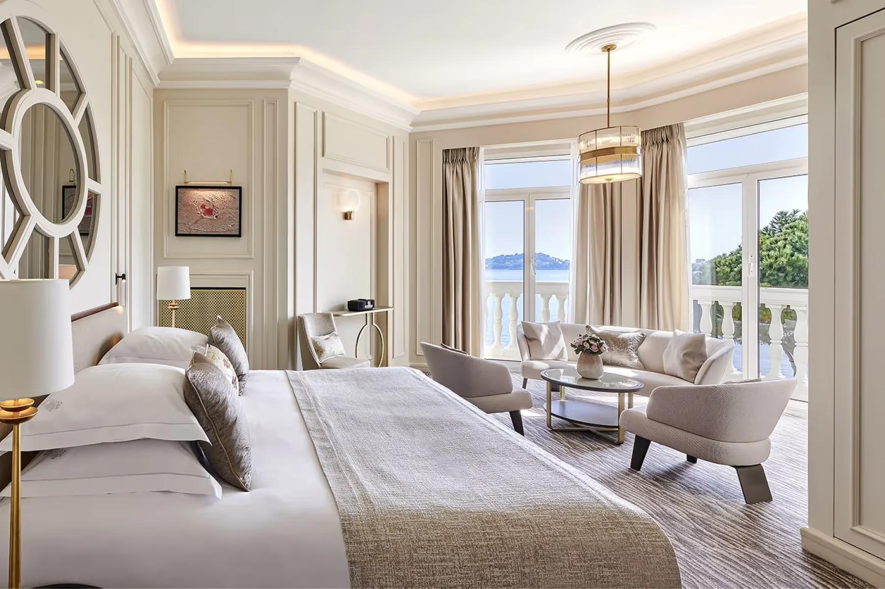 La Réserve de Beaulieu: bedroom with bed facing terrace, natural light, and sea view from balcony