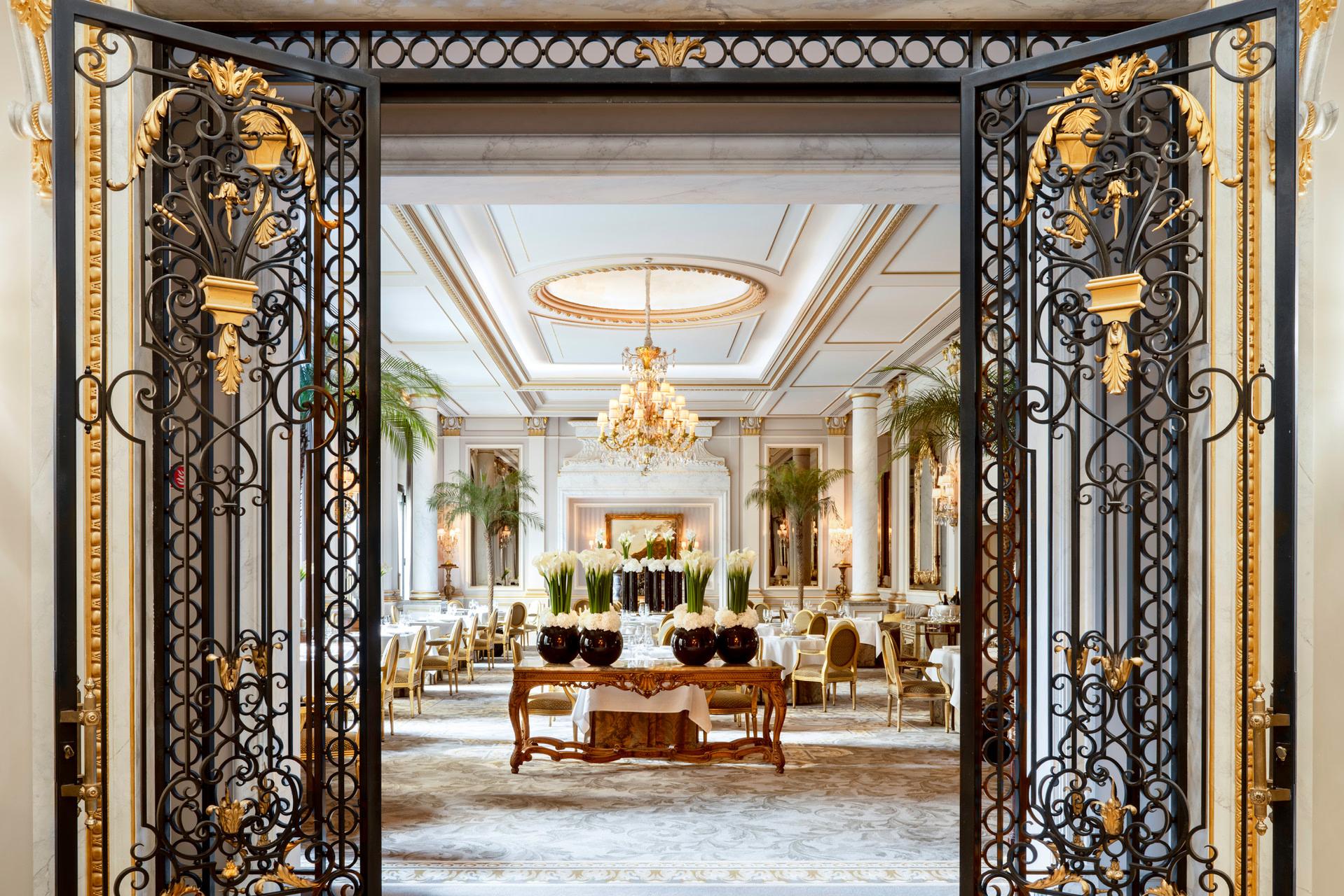 Four Seasons Hotel George V: a formal dining room with parquet floors, gilt chairs, and a classical ceiling