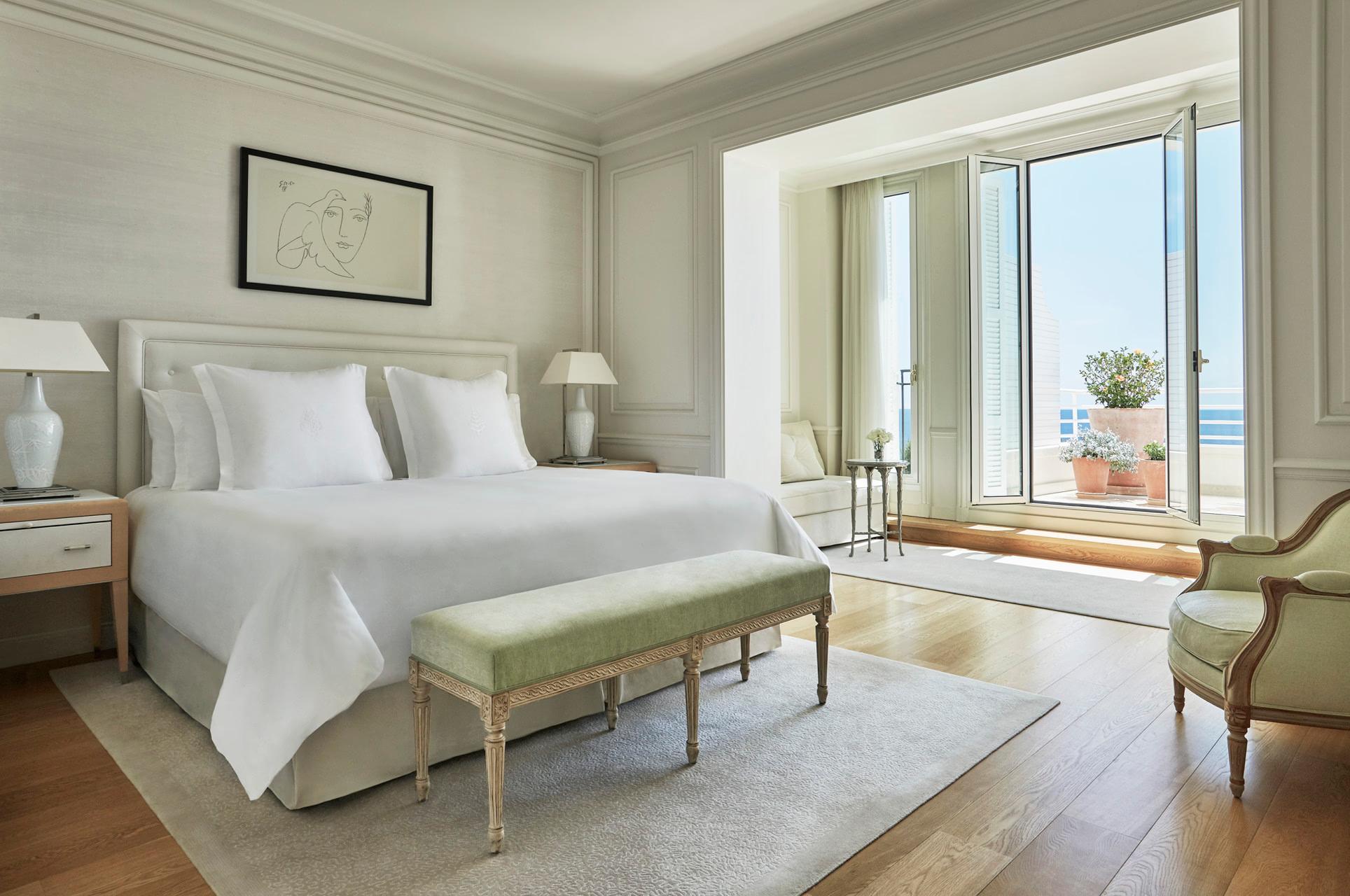 Grand-Hôtel du Cap-Ferrat: bright bedroom with white linens, floor-to-ceiling doors opening to a sea-view terrace