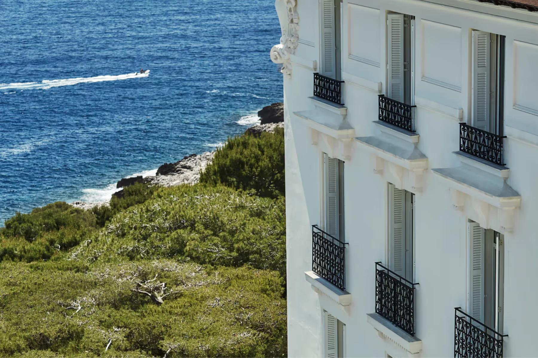 Grand-Hôtel du Cap-Ferrat: cream facade with wrought-iron balconies above rocky coastline