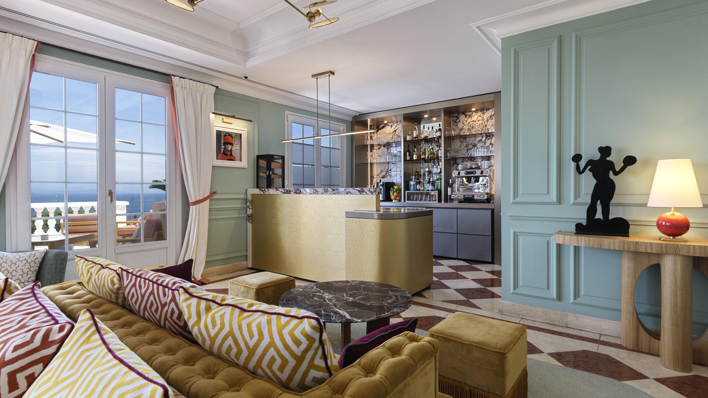 Althoff Villa Belrose: seafoam-accented lounge with geometric flooring and bay-view doors